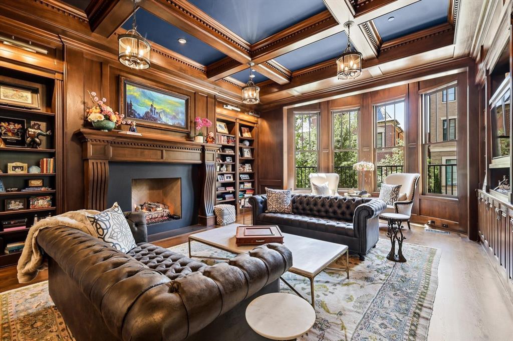 Introducing one of Southlake Town Square’s premier single-family Brownstone residences, this home offers the scale, privacy, and presence of a luxury estate while placing dining, shopping, cafés, and entertainment just moments from your front door. With DFW Airport only minutes away, it offers an exceptional balance of connectivity and convenience. Boiserie paneling, intricate ironwork, custom millwork, hand-blown Italian lighting fixtures, and stone fireplaces define the interiors. The main level unfolds through a grand foyer, richly appointed library with fireplace, office with built-ins, formal dining room with stone fireplace, and a relaxed living space centered around a stone fireplace. Flowing into the chef’s kitchen and screened outdoor living room with grilling station and built-in hood, the main living spaces are equally suited to entertaining and everyday living. The chef’s kitchen features luxury appliances, floor-to-ceiling cabinetry, an oversized island, and a walk-in pantry complete with a library ladder, secondary sink, and additional dishwasher. The owner’s level includes a primary suite, spa-inspired bath, custom dressing room, private laundry suite, and adjoining flex space with a built-in bar, ideal for a sitting room, office, wellness studio, or lounge. Upper-level suites offer en-suite baths and walk-in closets, while a game room with a built-in wet bar provides an additional gathering space on this level. A separate laundry room serves the upper-level accommodations. The lower level features an entertainer’s bar, gathering spaces, storage, and a cinema-style media room. Additional features include a fully integrated Savant smart-home system, whole-house generator, pet amenities, custom storage, elevator access to all levels, and an oversized four-car garage rarely found among Town Square residences. This combination of scale, craftsmanship, outdoor living, walkability, and privacy is rarely found within the heart of Southlake Town Square.