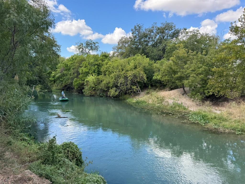 HALF-MILE RIVER FRONTAGE. Discover one of the most exceptional Central Texas riverfront properties for sale—a gated 105-acre estate with over ½ mile of direct San Marcos River frontage, perfectly positioned within the Austin–San Antonio–Houston corridor. This rare Texas land opportunity unites investment strength, natural beauty, and legacy potential in one extraordinary tract.

Set along the path of explosive regional growth, the property offers ½ mile of private, accessible riverbank with clear flowing water, open pastureland, and mature oaks that frame panoramic views—ideal for development, subdivision, recreation, hunting, fishing, equestrian use, or a luxury estate. This is premier Texas riverfront land for sale, featuring acreage with river access near Austin and waterfront property between San Antonio and Houston—a truly unique Central Texas land investment.

Just 40 minutes to Austin, 45 to San Antonio, and under two hours to Houston, this site offers privacy without isolation, only minutes from TX-130 and I-10 for effortless connectivity. Level topography, paved access, and available utilities support estate lots, eco-resort, or master-planned community concepts. For investors, it’s a tangible asset in Texas’s most proven corridor. For lifestyle owners, it’s a sanctuary for custom riverfront homes, private docks, equestrian facilities, and multi-generational enjoyment.

With few tracts offering half a mile of pristine San Marcos River frontage, this property defines rare Texas value—waterfront, location, and scalability united. Whether your goal is to build, invest, subdivide, or hold, this is a legacy asset of beauty, scarcity, and long-term growth within minutes of San Marcos. For those searching for Central Texas riverfront acreage, San Marcos River land for sale, waterfront property near Austin, or investment land between Houston and San Antonio will lead buyers directly to this exceptional opportunity.