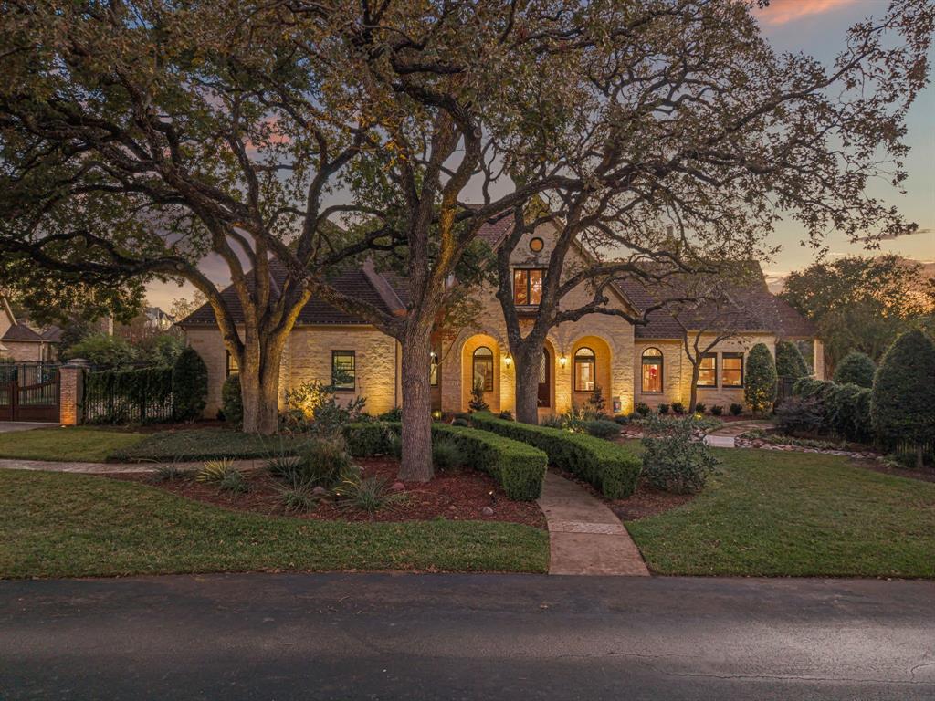 Situated among the rolling hills of Westlake, this stunning custom residence by renowned builder Scott Simmons rests on a premier oversized corner homesite within the exclusive gated enclave of Glenwyck Farms. Offering 4 bedrooms, a handsome private study with a dramatic see-through fireplace and an upstairs game room and media retreat, the home blends everyday comfort with refined elegance through extensive millwork and an abundance of natural light. The expansive professional-grade kitchen showcases abundant prep space, premium appliances and seamless flow for entertaining. A thoughtfully designed private teen suite features its own study area and a spa-inspired bath complete. Step outside to a resort-style oasis with a heated pool and grotto, spacious covered outdoor living, phantom screens and lush mature landscaping. Enjoy direct access to the Westlake Trails and walking distance to Life Time Fitness. Zoned to Westlake Academy or Carroll ISD, this exceptional property delivers luxury, lifestyle and location in one remarkable home.