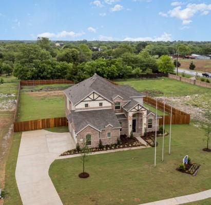 Ready for immediate move-in, this beautiful former Model Home spans nearly three-quarters of an acre. It features 4 bedrooms and 3 full bathrooms, plus a home office for work or study. The open floor plan boasts soaring ceilings in the living room and a wood-burning fireplace. The kitchen is equipped with an island, built-in stainless appliances, custom cabinets, and 
 backsplash. The primary bedroom includes a large walk-in closet, a separate shower, and a garden tub. There's also a secondary bedroom on the first floor, ideal for guests or relatives. A circular wrought iron staircase leads to an open game room upstairs, which overlooks the living room. Additionally, there are 2 bedrooms and a media room perfect for entertainment, watching the big game, or a movie night with the family. Outside, a covered patio offers views of the expansive backyard.