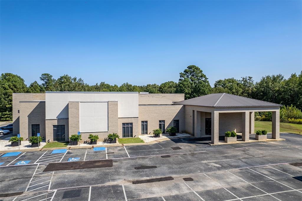 The Summit Club is a 17,000 square foot commercial property located in Longview, Texas, featuring a well appointed interior with multiple office suites, a spacious dining and reception area, a fully equipped commercial kitchen, a welcoming member lobby, a lounge, and several storage rooms. Currently operating as a private membership venue, the property is ideal for hosting weddings, corporate functions, and various social events. It sits on a 2 acre lot with ample parking for guests or staff, and there's potential to purchase additional adjoining acreage for future development. With its versatile layout, the building can continue to serve as an event venue or be repurposed for alternative commercial uses such as medical offices, professional workspaces, retail establishments, a fitness center, or more. Conveniently situated near downtown Longview, the property offers easy access to major roadways and local amenities. An additional 30 acres of surrounding land is also available for purchase, presenting a unique opportunity for expansion or large scale development.