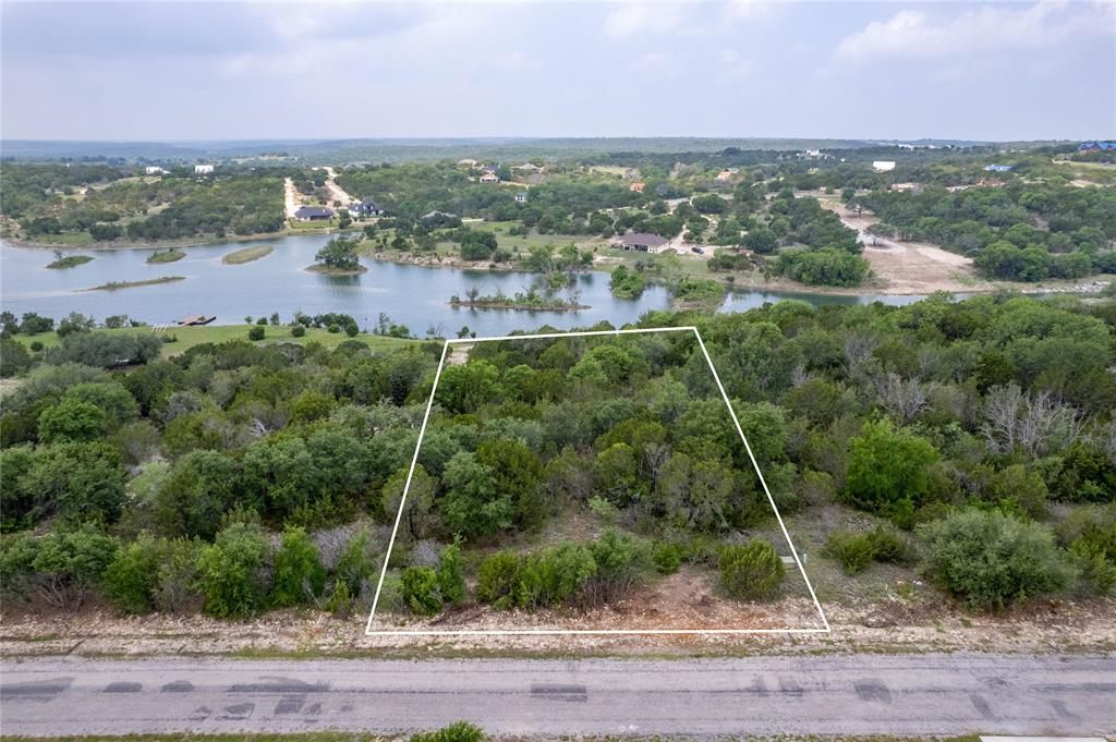 Waterfront property overlooking Anglers Cove Lake that is approx 45 acres, this 1+ acre parcel has water and electricity at the street, beach type waterfront on one side and deeper water on the other side of water frontage, this multi level lot is perfect for building street side, middle or lower level of this lot, the elevation changes show off the beautiful lake - build your home and enjoy the stunning views this property offers and take advantage of  the recreational opportunities with the two private lakes, community pool, club house, RV Park, and storage, along with a fantastic exercise park & pavilion. Bluff Dale, TX is located about one hour west of Fort Worth and convenient to Granbury, Glen Rose, Weatherford, and Stephenville.  Beat the city blues, come relax and enjoy the beautiful hill country that Bluff Dale Texas offers.
