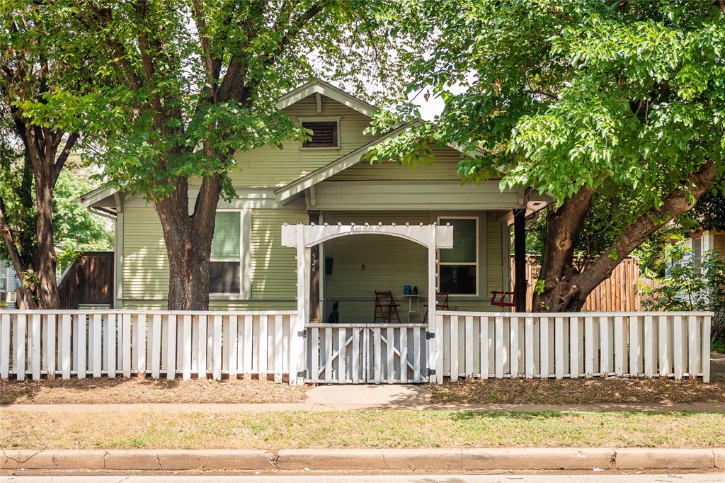 Some homes vie for your attention, but the quiet confidence of 526 S Edgefield need not boast. An unassuming Craftsman facade opens to reveal a blend of unique, complimentary textures that speak to both it's history and modernity. Inside, original shiplap accents run the walls and ceilings, its warm grain matching the hardwood floors. The open concept living and dining space flow into a contemporary kitchen with waterfall marble countertops, a farmhouse sink, glass tile backsplash, and stainless-steel appliances. Two spacious bedrooms offer built-in storage and plenty of closet space. The primary suite includes a spacious walk-in closet and primary bath is covered in marble with a dual vanity and matching textured tile floor and walk-in shower. Outside, you'll enjoy a side deck that takes you to the garden or a pergola-covered patio. An automatic electric gate guards both the driveway and alley entrance, leading back to a two-car garage (b.2015) with power, ready to build-out a shop or convert to livable space. The home was meticulously maintained and loved since it's complete renovation (2015) and updates where it counts including a full roof replacement (2022). Set within Winnetka Heights' walkable, historic pocket of West Oak Cliff, you're minutes from the neighborhood's best restaurants and shops, a rare pairing of old-soul charm that also meets today's modern needs. 526 S Edgefield is not built to chase trends, it outlasts them and endures.