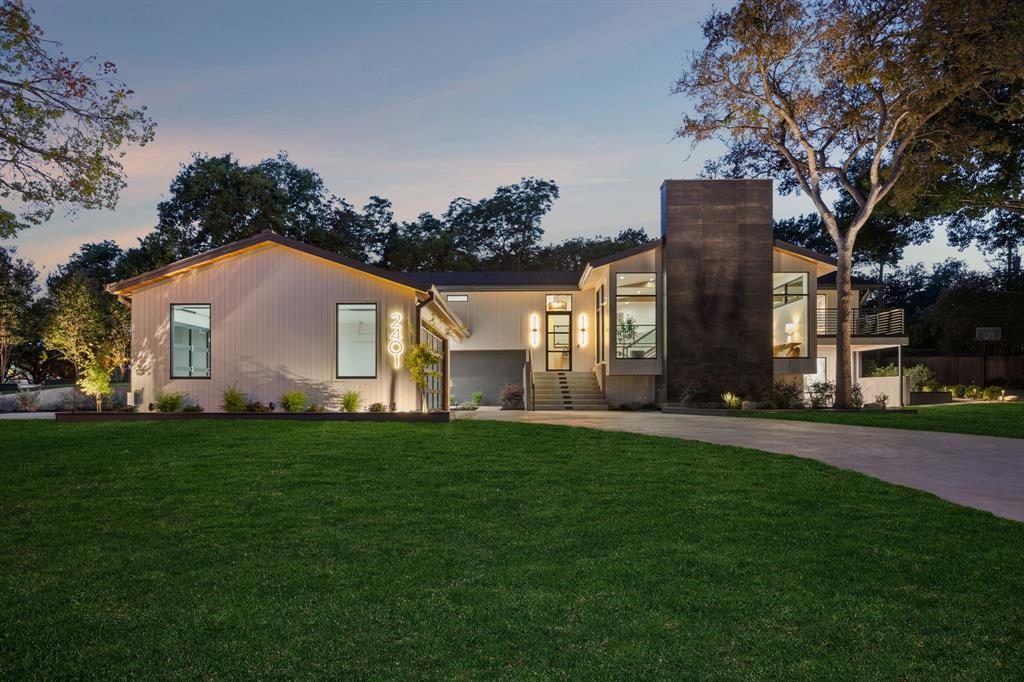 Welcome to a home that truly has it all—style, warmth, and a location that’s second to none. Just a short golf-cart ride from the Canyon Creek Country Club, this stunning reimagined residence sits on an oversized corner lot in one of Richardson’s most coveted neighborhoods. Every detail has been curated to balance modern sophistication with inviting comfort, perfect for both lively gatherings and quiet evenings at home. With five spacious bedrooms and five full baths, there’s room for everyone to relax. The main level features a sun-filled layout anchored by a chef’s kitchen with Thermador appliances, a natural stone island with soft underlighting, and illuminated glass cabinetry. Chunky wooden beams add warmth and character, continuing into the spacious living room for a cozy yet airy feel. The dining room, on a mid-level between the main and lower floors, is made for memories with a fireplace, vaulted ceilings, and large picture windows that brings in natural light. The main-level primary retreat offers a custom walk-in closet, dual sinks, and a luxurious bath with separate soaking tub and shower. Two additional bedrooms each have private baths. Downstairs, a second primary suite with a coffee bar opens to a Zen-style courtyard. The lower living area features an electric-start fireplace, wet bar with ice maker, show-stopping glass wine display, and a glass wine cellar. A fifth bedroom doubles as a guest suite or office with sliding doors to a tranquil front patio. Custom steelwork, white oak flooring, and detailed cabinetry showcase craftsmanship rarely seen today. Outside, enjoy a large, covered patio with cedar-planked ceiling, LED lighting, lush landscaping, and glass garage doors that slide open on both sides. Located in Richardson ISD, this home is more than beautifully designed—it’s a lifestyle, offering modern luxury, timeless character, and the welcoming spirit of Canyon Creek living.