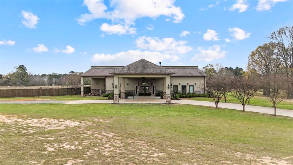 Set on 100 scenic acres in the East Texas piney woods, The Landing Event Center offers a rare opportunity to purchase both expansive land and a thriving event venue. The 8,228 sq. ft. commercial building is centrally located between Longview, Kilgore, and Henderson, just minutes from Gregg County Airport and less than a mile from Lake Cherokee. Built in 2015, this fully furnished, turnkey property blends refined style with classic Texas character. The venue is well suited for weddings, celebrations, corporate functions, Quinceañeras, and outdoor events, with flexible indoor and outdoor spaces that accommodate gatherings of all sizes. Interior highlights include a 1,400 sq. ft. banquet hall, a 2,100 sq. ft. event space with stage, and an inviting foyer featuring a fireplace and bar. Additional amenities include bride and groom suites, a commercial kitchen, generous storage, and room to expand. Surrounded by open pasture and wooded acreage, the property can host up to 250 guests indoors and more than 500 when utilizing outdoor areas. A unique on-site helicopter landing capability adds convenience for special or high-profile events. Located just five miles from the I-20 corridor and future development plans, this property is ideal for investors, partnerships, churches, or event operators. Don't miss your chance to own one of East Texas's most well known event and wedding venues!