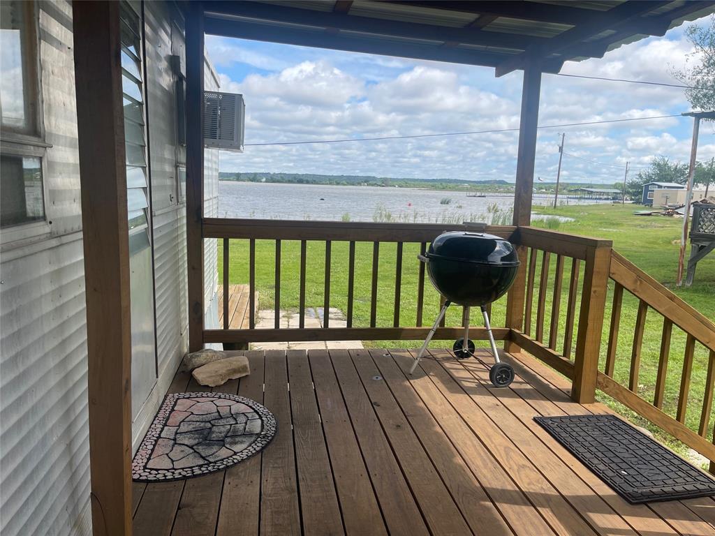Attention Retro Lovers! MOTIVATED SELLER is ready to  see offers on this adorable Vintage 2 bedroom 1 bath lake place!  Situated just a few steps from the water's edge, with amazing views and peaceful surroundings, this could be YOUR Possum Kingdom Lake retreat! Fully furnished (some decor excluded) and ready to use ~ bring your toothbrush, a cozy blanket, your swimsuit and prepare to enjoy and relax; there's even a fenced area for your furry friends! Listing is for improvements with leasehold rights: Sky Camp lease of $7500 per year includes trash, maintenance of common areas, and access to the community boat ramp, fish cleaning station, and courtesy dock for day use.  Summer will be back before you know it and you will have an ideal spot for baby splashers and young swimmers, shoreline fishing, paddle boats, kayaking, or canoeing; not far off the channel so it's also close to deeper water when you want to explore all of the beauty Possum Kingdom Lake has to offer.  Located near convenience stores, dining, gift shop, and churches.  Leave the daily grind behind and come enjoy the PK Lake Life!