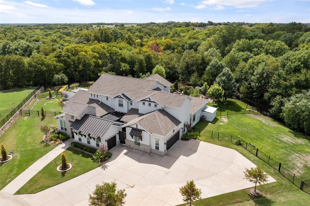 9.11 Seller Reviewing offers today at 5pm!  Enjoy country living close to the city. This Exquisite Entertainer's Dream home sits on 1.5 wooded acre lot & backs to treelined creek which will never be built on. As you enter front gate enjoy dynamic courtyard & covered entry which opens to grand 2 story foyer. Chef's kitchen offers massive quartzite island, Wolf gas range stove, Subzero frig, freezer & wine frig. and opens to dining rm w beautiful chandelier & wall of windows. Impressive family room w cozy fireplace, built-ins & sliding glass doors w amazing views of 50,000 gallon Koi pond. Luxurious Master suite w tray ceilings w spa-like ba including sauna & custom closet. Additional features include office, game, media, separate in-law quarters w family rm & en-suite. Outdoor dining area w built in grill, frig, freezer and sink is perfect for entertaining. Relax by outdoor fireplace or go for a swim in beautiful pool, spa, gardensm rock climbing wall and more!!