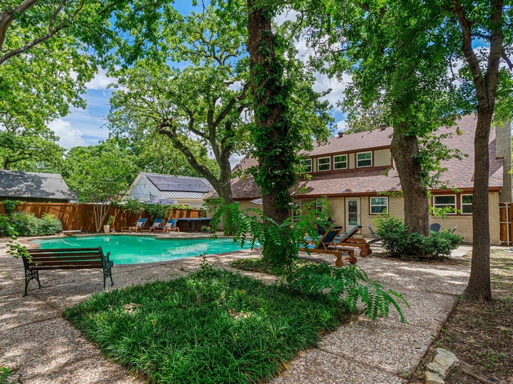Motivated Seller! Bring all offers! Homes like this don't come around often because of how it lives. There’s a balance here that’s hard to find… original character, thoughtful updates, and a unique layout. Built in the late 40s, this home carries the kind of character you just don’t find anymore. Original hardwood floors, real room separation, and a layout that feels intentional instead of trendy. At the same time, the updates have already been done, so it lives the way you expect today. With over 3,100 sqft, the space here isn’t just bigger, it’s more usable. Multiple living areas give you flexibility with how life actually looks. There’s a true dining space, a large living room filled with natural light, and a layout that doesn’t force everything into one open box. The kitchen has been modernized with granite counters, updated appliances, and a functional setup that works when you’re cooking or hosting. Nothing feels squeezed or like an afterthought. Upstairs is where things get interesting. Two separate staircases create a sense of privacy and flow that you rarely see. The primary suite is oversized with its own sitting area, walk-in closet, and cedar storage. Secondary bedrooms are spread out, giving everyone their own space. Storage is another standout here. Between built-ins, hidden storage rooms, and a full utility space with room for an extra freezer, this home solves problems most houses ignore. Step outside and it completely changes the vibe. The backyard changes everything. The pool creates a private space that’s easy to enjoy year round, whether it’s a quiet night or a full house on the weekend. Location is the final piece. Set just minutes from downtown FTW, the Trinity River, and major highways, you get quick access without feeling like you’re in the middle of the chaos. It’s one of those pockets people discover and don’t want to leave. It’s a home with personality, space, and function, in a location that continues to get better over time.
