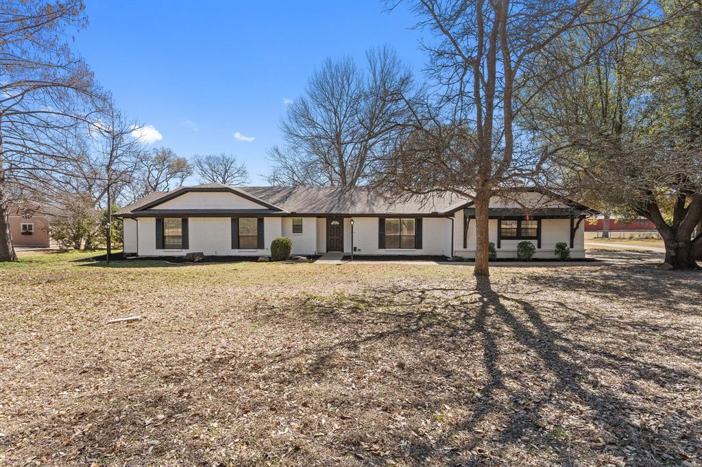 Situated on over an acre just off Country Club on Camino Real, this beautifully updated 4-bedroom home offers the perfect blend of privacy, space, and convenience — all in the highly sought-after Lovejoy ISD.

Step inside to an inviting open-concept layout where the kitchen flows seamlessly into the spacious living area, creating the ideal setting for everyday living and effortless entertaining. The kitchen shines with high-level granite countertops, stainless steel appliances, and abundant prep space, while the large formal dining room is ready to host memorable gatherings.

A versatile sunroom adds flexible living space — perfect for a playroom, workout room, second living area, or peaceful retreat overlooking the backyard. Rich wood flooring enhances the main living areas, with plush carpeted bedrooms offering comfort and privacy. A dedicated office with custom built-in shelving makes working from home both functional and inspiring.

Out back, enjoy your own private escape. With no neighbors behind you, mature shade trees, and an expansive yard, this property delivers rare tranquility and room to roam. The long driveway provides generous parking space in addition to the attached 2-car garage.

If you’ve been searching for space, privacy, and top-tier schools — all wrapped into a move-in-ready home — this one checks every box.