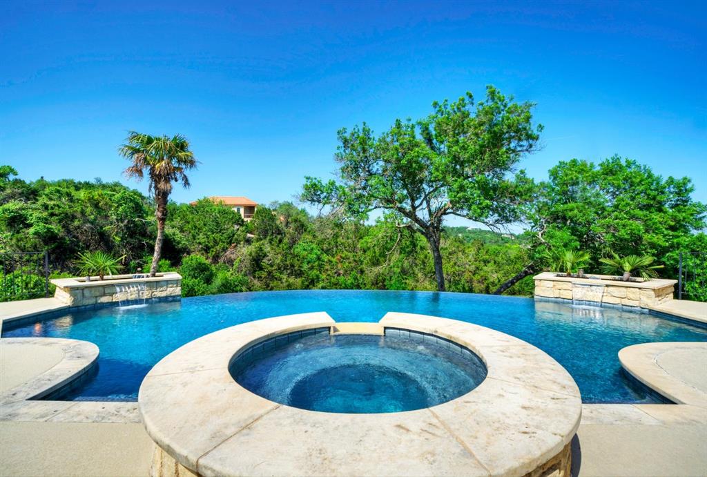 Set on 2.3+ acres in the gated community of original Rob Roy, this property offers the perfect blend of privacy and timeless Hill Country charm. Surrounded by mature trees and meticulous landscaping, the home is a true retreat, offering a tranquil, private oasis just minutes from the city.

Spanning 4,149 sq ft, the residence features 4 bedrooms, 4 full baths, and 2 half baths (including one dedicated to the pool area). The open-concept layout welcomes you with Hill Country views and seamless integration between indoor and outdoor spaces. High ceilings and abundant natural light enhance the home’s warmth.

The main level is designed for both comfort and style. The primary suite offers direct pool views and a spacious bathroom, creating a peaceful retreat. A dedicated office just off the foyer provides the perfect space for remote work or quiet reflection.

The kitchen and breakfast area are designed for gathering, flowing into a family room ideal for everyday living and entertaining. Each secondary bedroom includes its own en-suite bath and access to a separate living area—ensuring privacy and comfort for guests or family.

Step outside to enjoy 700+ sq ft of covered outdoor living, where a negative-edge pool with cascading waterfalls seamlessly blends into the natural landscape. An outdoor shower adds to the experience.

Thoughtful design details abound: 8-ft doors, two fireplaces, a wet bar, central vacuum system, and an instant hot water recirculation pump. Recent upgrades include fresh stucco and paint, new windows with a transferable lifetime warranty, two tankless water heaters, and a re-plastered pool with updated equipment.

Located in the coveted Eanes ISD with one of the lowest tax rates in the Austin area, this is an extraordinary opportunity to own a Hill Country estate in one of Austin’s most desirable neighborhoods.