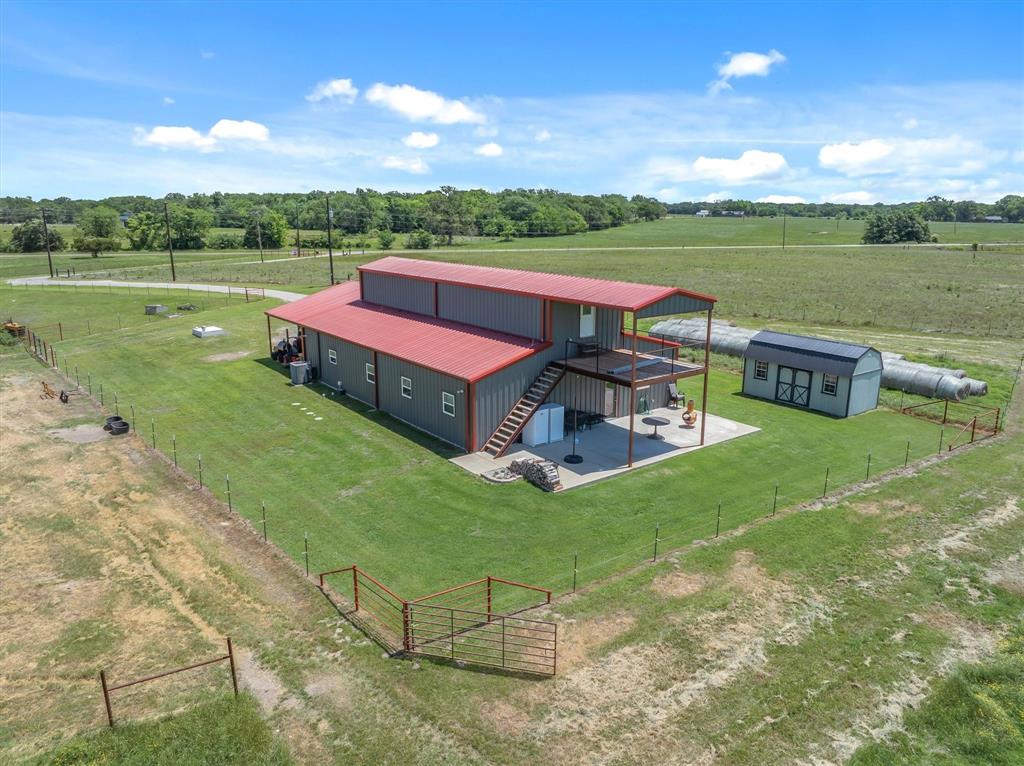 Welcome to your East Texas dream property! This beautiful custom-built barndominium, completed in 2021, offers approximately 2,400 square feet of living space with 4 bedrooms and 3 bathrooms, perfectly situated on approximately 21.34 scenic acres just outside the city limits. Enjoy the peaceful setting featuring a stocked pond, spring-fed creek, and plenty of open pasture for your cows, horses, and outdoor lifestyle. The home offers modern finishes, spacious living areas, and a functional layout designed for comfort and entertaining. An additional 900 square feet of insulated, spray-foamed space provides endless possibilities, create a game room, guest quarters, home gym, office, or additional living area to fit your needs. The property is equipped with a water well, a secure front entry gate, and a 10x20 shed complete with a tornado shelter for added peace of mind. Conveniently located with easy access to local schools while still enjoying the privacy and freedom of country living, this property truly offers the best of both worlds. Bring your animals, your hobbies, and your vision...this one has room for it all!