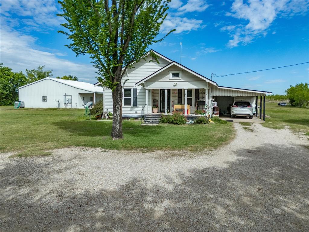 Charming and full of potential, this adorable 1,076 SF home sits on a beautifully maintained 1-acre property with a gated entry, offering both privacy and versatility. The main residence features 2 bedrooms, 1 bath, and a cozy eat-in kitchen, perfect for comfortable everyday living.  A standout feature is the impressive 1,200 SF shop, complete with an enclosed 1-bedroom apartment that is currently income-producing—ideal for rental income, guest quarters, or a home-based business setup.  Surrounded by mature trees and a manicured yard, the property provides a peaceful, country-like setting while still being conveniently located off Hwy 34 in Ennis. Enjoy easy access to shopping, dining, and Hwy 45 for a smooth commute to Dallas.  Zoned residential and situated on two parcels, this property offers incredible flexibility. The existing structures can serve as a primary residence, office, or both, with potential for commercial use (buyer to verify).  Whether you're looking to live where you work, invest, or create your dream home, this unique property offers endless possibilities in a serene setting.