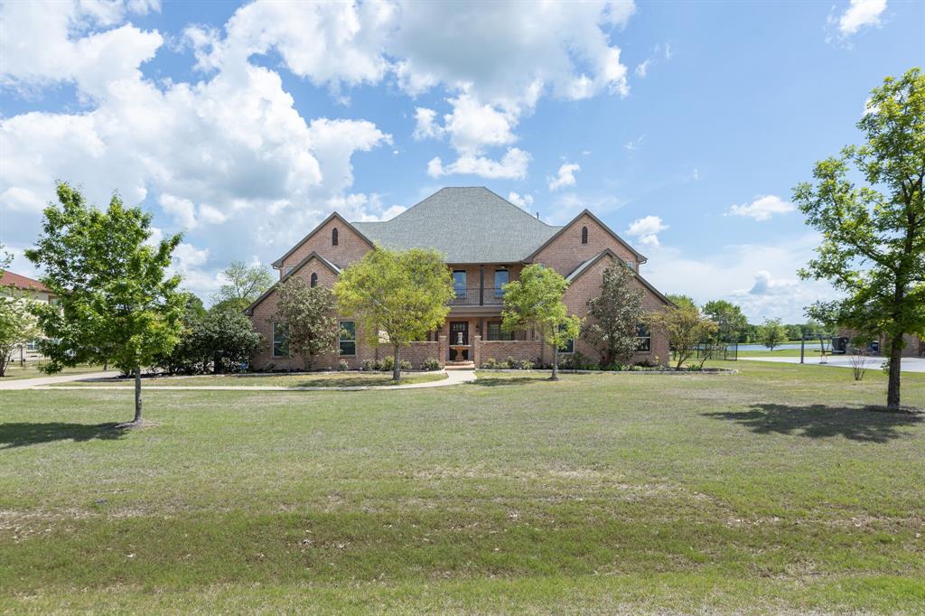 Unbelievable custom home on 1.42 ac in a beautiful gated community! Enter through the peaceful courtyard with fountain to find features like TWO primary suites, wonderful open floorplan, 20' ceilings in living & foyer, open staircase, heavy crown molding, WBFP & beautiful custom detailed cabinetry, grand eat-in kitchen with lg granite island & recently upgraded with top rated appliances, bonus storage areas, a hobby rm or office, 2 oversized bedrooms, one can be a bedroom & playroom combo, spectacular view of the property & community pond, and lg game room is adjoined by a family rm with lots of blt-ins and all have access to the 2 balconies of the home + so much more! Exterior boasts a BRAND NEW ROOF, gutters & screens, a 24x48 sqft shop that can hold an RV with 30 & 50 AMP plugs, tons of storage & a half bath, and a perfect space for entertaining with a great awning over the new Blaze outdoor kitchen while enjoying the outdoors!