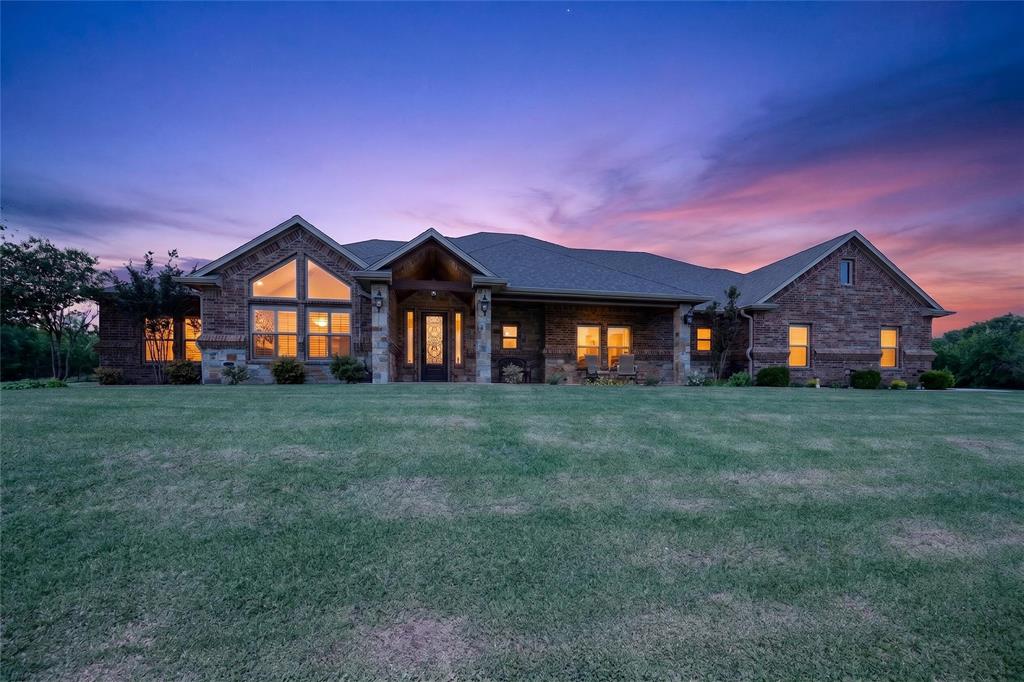 Beautiful 4 bed, 3.1 bath with en-suite, and custom 3 Car Garage on 3.8 acres! This is truly one of the finest built homes in Gunter. Features include a safe room, walk-up staircase in the garage to an amazing attic storage area, spray foam insulation, and exclusive privacy. Open concept custom stone, brick, wood floor home features an amazing chef's kitchen with high-end stainless steel appliances, a walk-in pantry, pot filler, and a large center island with vaulted cathedral ceilings and dark stained beams. The home includes smart thermostats, on-demand water heaters, hail-resistant shingles, a massive fireplace with custom mantle, crown molding throughout, and plantation shutters, all supported by a slab with 61 piers. The garage is wired with 220 for a welder or your EV car. The dining area walks out to an outdoor kitchen complete with Blaze grill, sink with hot and cold water, and separate entrance into two primary bedrooms.  Come see the stocked pond with a gorgeous water fountain, and all the breathtaking views this beautiful home and property can provide.