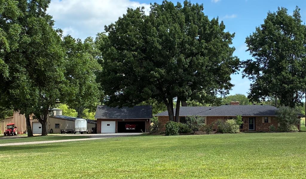 GREAT LOCATION!!  Welcome to your 8.4-acre ag-exempt homestead.  Nestled amidst wide-open views, wildlife, and mature pecan trees, this property is a true oasis for nature lovers and animal enthusiasts alike. The 2,164 sq. ft. main residence boasts an open living area with WB fireplace, 2 dining areas, fresh paint, upgrades include appliances, flooring, HVAC, and stylish kitchen renovations. With cross-fencing in place, it’s perfect for raising animals or letting your furry friends roam freely. Equipped for your agricultural passions, the property includes a well-appointed 3-stall barn complete with a hayloft, tack room, workshop area, and an office space—perfect for managing your farming endeavors or animal care. Whether you're tending to horses, goats, or other livestock, this farm is ready to support your rural lifestyle. For those who appreciate fishing, two serene ponds are stocked with bass, catfish, and crappie—ideal for weekend afternoons spent casting a line. Looking to generate additional income? The charming 1,800 sq. ft. 3-bedroom, 2-bath guest house provides an excellent opportunity for an Airbnb or long-term rental. With its own unique character and ample space, guests will revel in the tranquility of the countryside. Convenient access to schools, shopping, dining, and major highways. With a rare combination of features and a prime location, this hidden gem is waiting for the right buyer. Don't miss the chance to own this exceptional property— where dreams of country living come true!