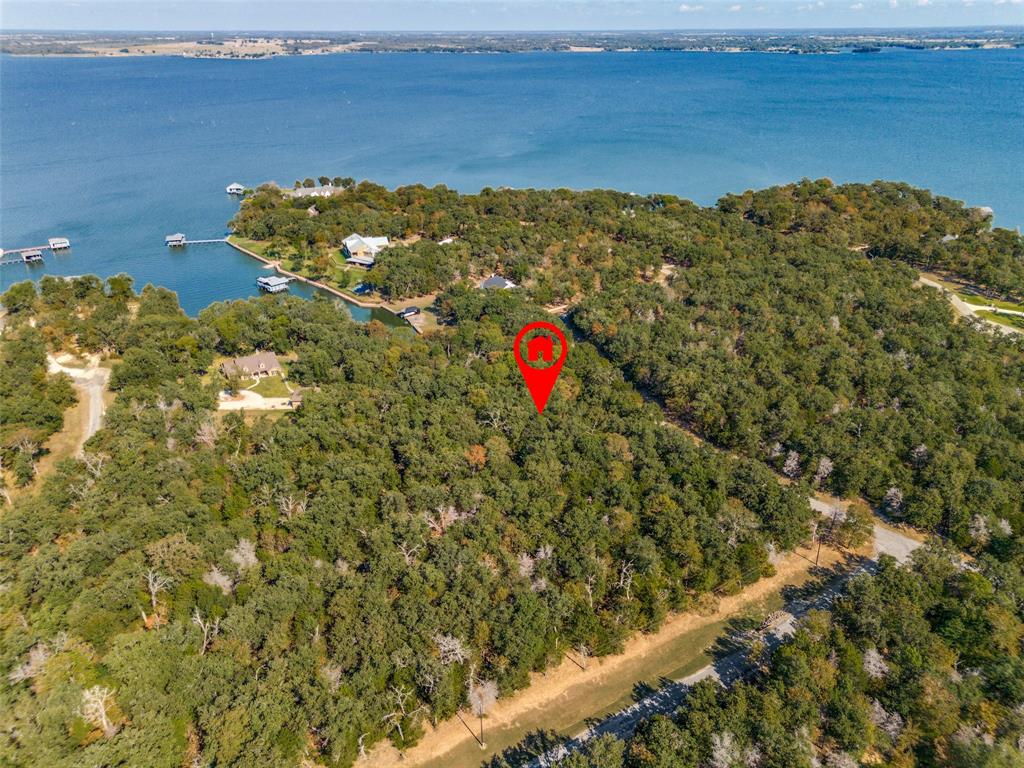 Discover the unparalleled beauty and tranquility of lakefront living with this exceptional offering at Richland Chambers Lake. Nestled within the prestigious The Woods subdivision, this 4.95-acre property is a fusion of privacy, natural beauty, and accessibility.
Comprising two spectacular lots, this parcel provides a rare combination of extensive lakefront access and the seclusion afforded by mature hardwood trees. Imagine crafting your dream home amidst this serene landscape, where every window captures stunning views of the lake and the surrounding woodland.
With substantial road frontage, access to both lots is seamless, ensuring convenience without compromising the harmony of the natural setting. This is more than just land; it's an invitation to create a lifestyle of peace, luxury, and connection with nature.
Seize the opportunity to own a piece of paradise in one of the lake's finest communities. Experience the ultimate in lakeside living and make your dream home a reality today