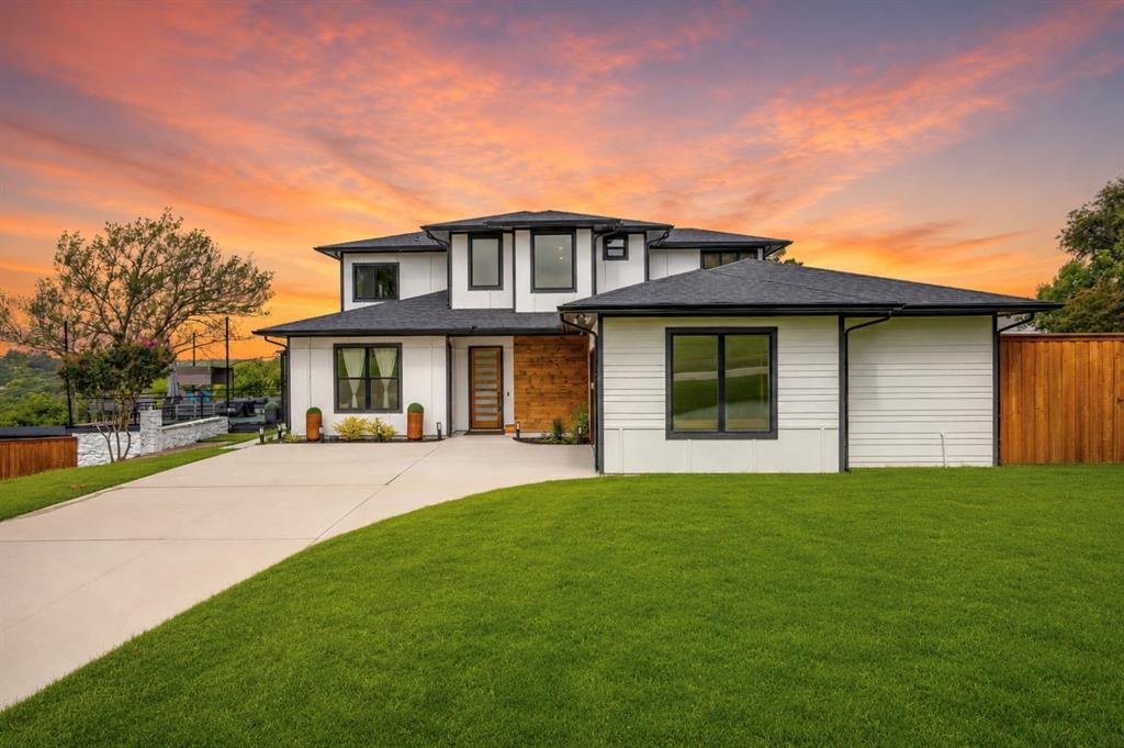 Experience elevated Texas living in this exceptional contemporary estate, positioned on a scenic one-acre hilltop lot in the Tejas Trails community. Showcasing panoramic views and modern architecture, this one-of-a-kind property offers an unmatched blend of sophistication, flexibility, and opportunity. From the moment you step inside, you'll be captivated by abundant natural light, designer finishes, and walls of windows that frame the surrounding landscape. The open-concept floor plan was designed for both everyday comfort and effortless entertaining, featuring a chef-inspired kitchen with a commercial-grade range, oversized island, and seamless flow into the spacious living and dining areas. The luxurious primary suite serves as a private sanctuary on the main level, offering a spa-inspired bath, walk-in closet, and peaceful views. Upstairs, a large secondary living area and versatile loft provide the perfect space for a media room, game room, home office, fitness area, or creative retreat. Outside, the possibilities continue. In addition to the oversized two-car garage and detached carport, a 60' x 30' concrete pad with water and electrical service is ready for your dream workshop, RV garage, studio, or guest accommodations. Adding remarkable value are two separate living spaces. The fully equipped pool house loft offers independent living quarters, while the custom-built cottage tucked into the lower portion of the property creates a charming private retreat for guests, extended family, multigenerational living, or income potential. The fenced backyard is enclosed by an 8-foot cedar privacy fence, creating a secluded outdoor oasis. Energy-efficient windows and appliances, a propane range, and a tankless water heater enhance comfort and efficiency. Rarely does a property combine modern luxury, breathtaking views, multiple living options, and room to grow in such a spectacular setting. This Tejas Trails estate offers a lifestyle limited only by your imagination.