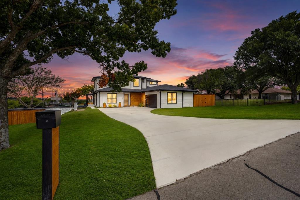 Experience elevated Texas living in this exceptional contemporary estate, positioned on a scenic one-acre hilltop lot in the Tejas Trails community. Showcasing panoramic views and modern architecture, this one-of-a-kind property offers an unmatched blend of sophistication, flexibility, and opportunity. From the moment you step inside, you'll be captivated by abundant natural light, designer finishes, and walls of windows that frame the surrounding landscape. The open-concept floor plan was designed for both everyday comfort and effortless entertaining, featuring a chef-inspired kitchen with a commercial-grade range, oversized island, and seamless flow into the spacious living and dining areas. The luxurious primary suite serves as a private sanctuary on the main level, offering a spa-inspired bath, walk-in closet, and peaceful views. Upstairs, a large secondary living area and versatile loft provide the perfect space for a media room, game room, home office, fitness area, or creative retreat. Outside, the possibilities continue. In addition to the oversized two-car garage and detached carport, a 60' x 30' concrete pad with water and electrical service is ready for your dream workshop, RV garage, studio, or guest accommodations. Adding remarkable value are two separate living spaces. The fully equipped pool house loft offers independent living quarters, while the custom-built cottage tucked into the lower portion of the property creates a charming private retreat for guests, extended family, multigenerational living, or income potential. The fenced backyard is enclosed by an 8-foot cedar privacy fence, creating a secluded outdoor oasis. Energy-efficient windows and appliances, a propane range, and a tankless water heater enhance comfort and efficiency. Rarely does a property combine modern luxury, breathtaking views, multiple living options, and room to grow in such a spectacular setting. This Tejas Trails estate offers a lifestyle limited only by your imagination.
