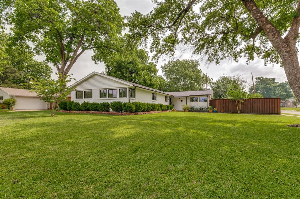 This home is updated, move-in ready and sits on a large corner lot with close proximity to private schools. Updates include new appliances, refinished hardwood floors, fresh paint throughout, and more. The flexible floorplan has 2 primary bedrooms - one with a huge walk-in closet and its own sitting area, nursery or game room. The second primary bedroom is on the opposite side of the house making this a home perfect for roommates, or a multi-generational living situation. The second living area at the front of the house makes the perfect warm and cozy library -- it has tons of natural light, so I could see myself sitting in front of the fireplace all day enjoying a nice book. The kitchen has tons of cabinet and counter space and includes a separate coffee bar. Large yard with privacy fence.