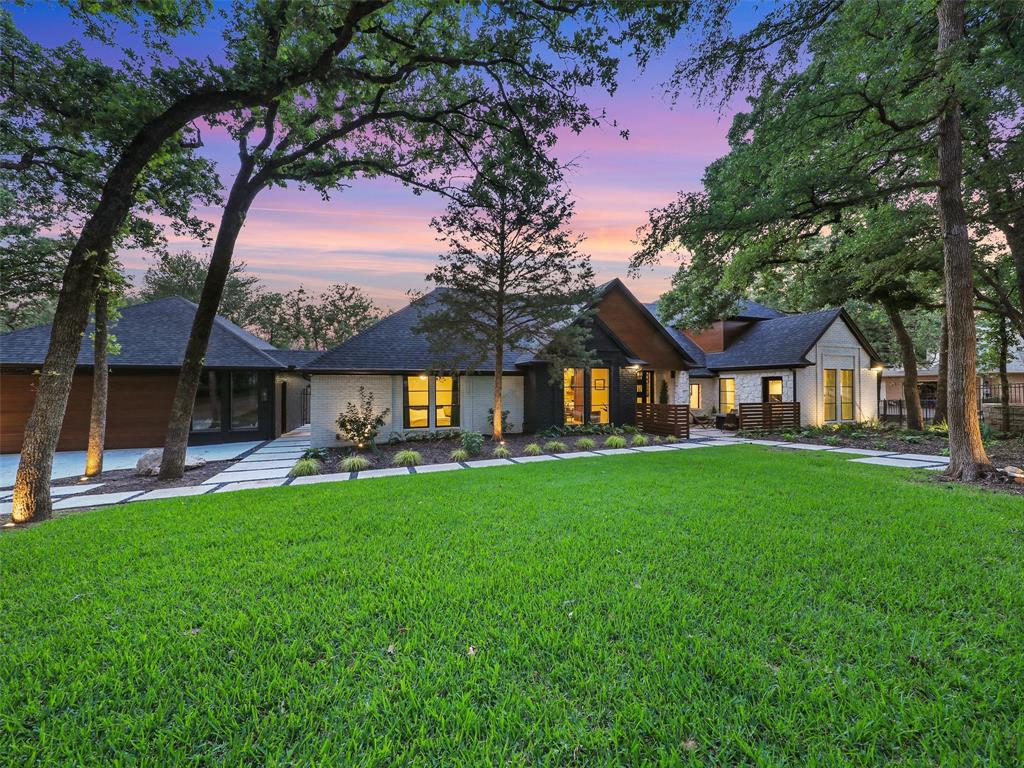 Welcome home to this incredible, Completely Renovated MODERN home on waterfront ACREAGE with its own private dock. ** OPEN ENROLLMENT TO CARROLL ISD ** Step inside to a stunning Great Room w soaring ceiling open to professionally designed Chef's Kitchen featuring top-of-the-line appliances & sleek finishes. New glass-enclosed Wine Cellar + stylish full Wet Bar. Gorgeous Primary Retreat with spa-like bath & new barn doors. This exceptional property includes a charming 2 story Guest House perfect for visitors or an additional retreat. Gorgeous sparkling pool + spa. Upgraded new outdoor upgrades include an irrigation system overhaul, exquisite Landscaping enhancement, state-of-the-art fence w automatic sliding gates, and new attached patio cover with full Outdoor Kitchen boasting a fireplace, lighting, and integrated Sonos system. Enjoy your own recreational amenities with zip line, tree swings, charming treehouses nestled amidst mature trees & loads of grassy areas for play. Truly an outdoor playground and the inside is a Modern gem!