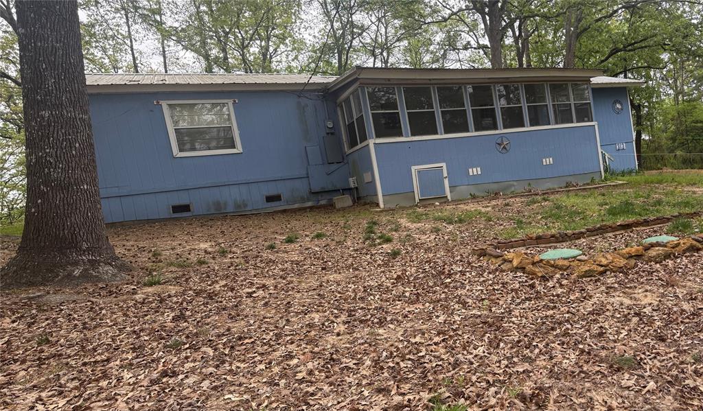 Look at this 2 bed, 2 bath, 1459 sq ft home on 4 lots Located in the Big Woods Springs community. This property is sold as, but offers the potential for endless possibilities. The house features a wall heater with its own propane tank & 2 window units to keep you cool in the summer and warm in the winter. It also features a storage building for the lawnmower and outdoor tools & a cover 2 vehicle carport. This property features Turkey Creek lake, a 90 acre lake and a community club house.