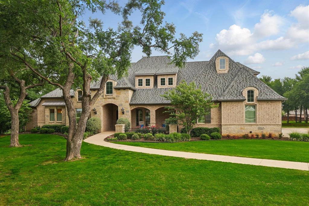 Luxury Living Redefined – Private Estate with Guest House, Pool, & Endless Amenities on 2 Acres.  Prepare to be captivated by this extraordinary 1 story estate offering unmatched luxury, privacy, & functionality on a beautifully manicured & heavily treed 2-acre lot. With 5 spacious bedrooms, 4.5 bathrooms, 4 fireplaces & over-the-top custom features this home is a true masterpiece designed for both comfort & sophistication. The heart of the home opens to expansive living & entertaining spaces highlighted by soaring ceilings, custom finishes & seamless indoor-outdoor flow. The gourmet kitchen & multiple living areas overlook a resort-style pool & spa perfectly situated between the main home & a fully equipped guest casita. The guest house offers a full living area, bedroom, bath, kitchenette, laundry, & additional loft bedroom—ideal for extended family or guests. Retreat to your private owners’ sanctuary with separate sitting room & fireplace, walk-in shower & custom-designed closet worthy of a boutique. Enjoy 2 dedicated studies—1 with its own hidden foundation-bolted safe room & the 2nd located quietly at the rear of the home. Flex room next to media room is currently used as home gym but includes a closet a & sits adjacent to a handicap-accessible bathroom making it perfect as a 5th bedroom option.  Two bedrooms feature direct access to a private screened patio—the perfect place to unwind. Outdoors, you’ll find a massive covered patio with fireplace, poolside fire pit, spa, & generous entertaining spaces. The 3-car garage offers 50-amp service, a storm shelter, and huge overhead storage. Plus—a rare bonus—the property already has an approved variance for a 42-foot RV garage. CAT5 data ports and mesh WiFi ensure connectivity throughout.  All this, nestled in a quiet, serene setting that feels like country living, yet just minutes from the best shopping, dining, and entertainment Highland Village has to offer. This is more than a home—it’s an elevated lifestyle.