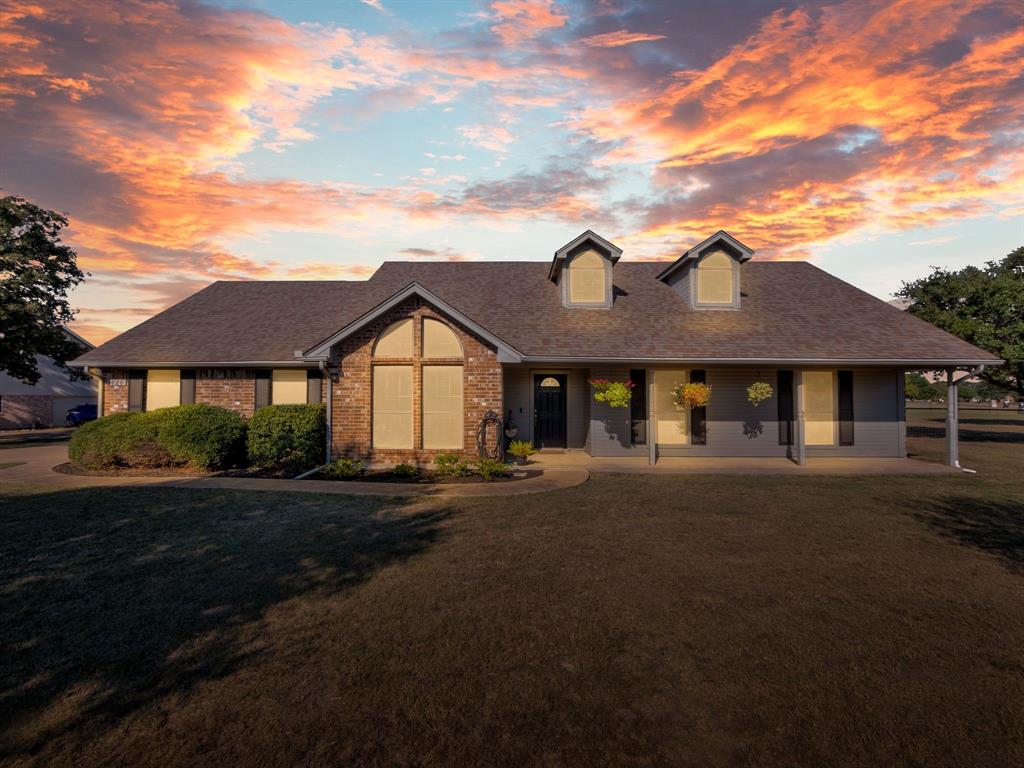 Welcome to this beautifully updated 4-bedroom, 2-bath home on a desirable corner acre lot. Inside, you'll find fresh paint throughout and updated laminate flooring. The bright kitchen features updated appliances and opens to a cozy dining area — perfect for family meals and entertaining. At the heart of the living space is a stunning wood-burning fireplace, creating a warm and inviting focal point for gatherings or quiet nights in.  The spacious primary bedroom offers a relaxing retreat with updated carpet, two walk in closets, and complete with an ensuite bathroom featuring a garden tub. Split floor plan places three additional guest bedrooms and a full guest bathroom on the opposite side of the home providing  privacy for family or visitors. Enjoy peaceful mornings on the welcoming front porch and relaxing evenings on the covered back porch, overlooking a large, private backyard with plenty of room to roam, garden, or play. Don’t miss the chance to call this property your new home!!