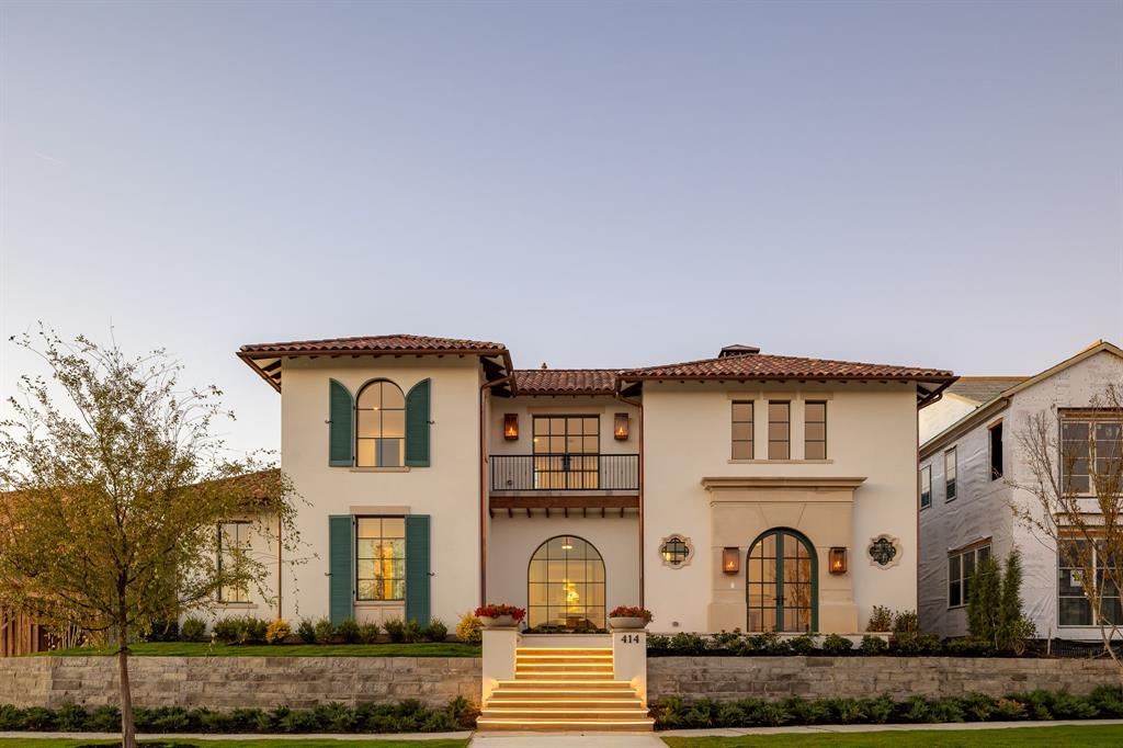 Welcome to The Preserve in Frisco, one of the nation’s most sought-after gated communities, set among rolling hills and anchored by two PGA championship golf courses. This exceptional custom home by Coats Homes showcases refined transitional design with the rare advantage of immediate move-in—offering elevated living without the wait. Santa Barbara-inspired architecture by Jerry Coleman pairs seamlessly with sophisticated interiors by Park Interiors, delivering remarkable craftsmanship, curated finishes, and premier amenities just moments from nature trails, dining, shopping, and world-class golf. Spanning 5,915 square feet, the home offers 5 bedrooms, 5 full baths, and 2 half baths, along with a game room, dedicated gym or media room, study, and an oversized three-car garage—all wrapped in an authentic barrel clay tile roof. A grand two-story entry makes an immediate impression, welcoming guests through steel doors onto limestone floors, where a fireplace and sweeping spiral staircase create a dramatic sense of arrival. Floor-to-ceiling windows flood the home with natural light, highlighting wide-plank oak hardwood floors, beautiful millwork, and smooth-finished walls. The chef’s kitchen is a true showpiece, appointed with Wolf & Sub-Zero appliances and an exceptional working pantry designed for both functionality and entertaining. The family room is anchored by a striking see-through fireplace and flows seamlessly into the kitchen and dining areas, while the study-lounge features thoughtful built-ins for a refined, functional retreat. The first-floor primary suite offers privacy and comfort, complemented by two laundry rooms—one on each level. Upstairs, four en-suite bedrooms with walk-in closets provide separation and flexibility, along with a spacious game room and dedicated gym or media room. Designed for year-round enjoyment, the outdoor living spaces connect effortlessly through LaCantina sliding doors and feature a fireplace and in-ceiling heaters.