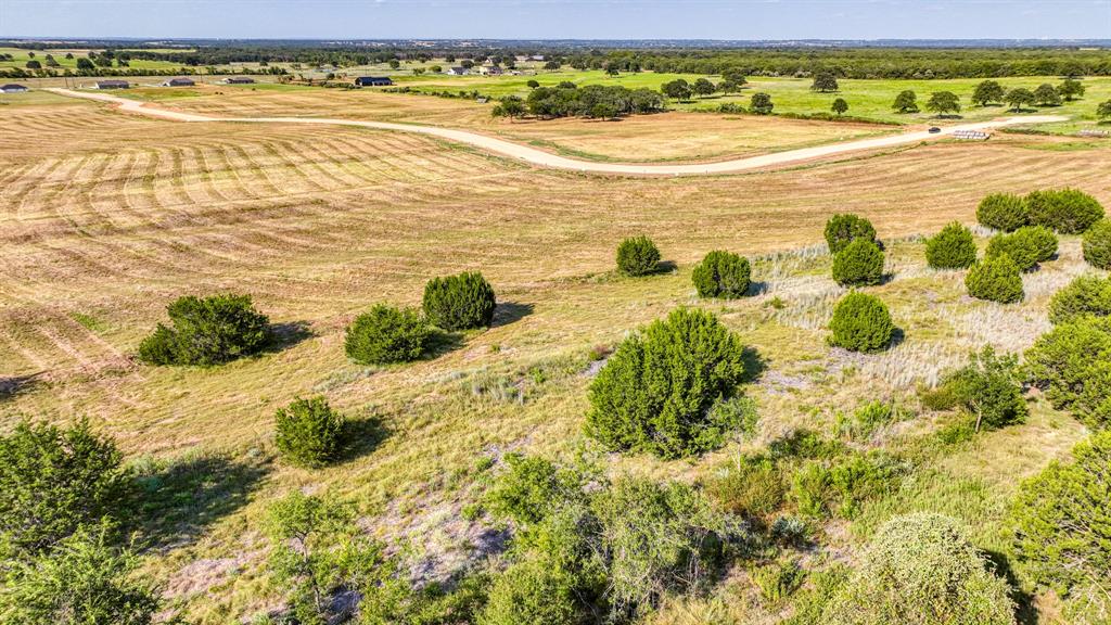 Wide lot with multiple build sites available! Enjoy open land dotted with beautiful trees, all while benefitting from NO CITY TAXES, NO HOA, and NO WATER BILL! Located just 25 minutes from Weatherford and under an hour from downtown Fort Worth, this rural gem offers both tranquility and convenience.  Animal enthusiasts will love the freedom to bring horses, cattle, chickens, and more. Temporary on-site living and RVs are also permitted. Choose from custom plans with our preferred Zeal Home Builder or opt for semi-custom homes, including Barndominiums! Guest houses and second homes are allowed, making it ideal for multi-generational living. Explore financing options with Veteran Land Board Loans or low-down conventional options. Still deciding on your dream home? You can invest now and build later, with no time limit to build. Parallel Pastures is thoughtfully restricted to protect your investment while providing the freedom to enjoy your own land. Don’t miss out on this opportunity. These rural homesites are ideal for you to own your piece of one of the fastest growing counties in Texas. Don’t wait to buy land, buy land & wait! Txt keyword PASTURE2 to 88000 for Restrictions & current inventory.