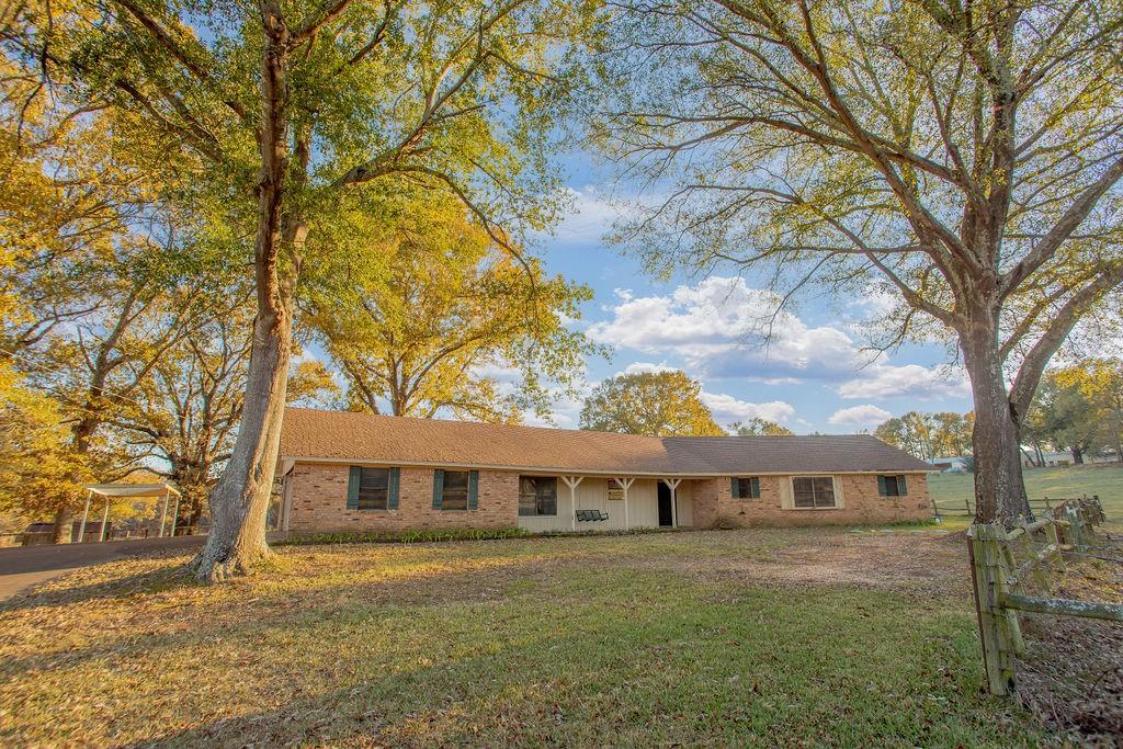 Rare find in Tyler & Smith County! This 4 bedroom, 2.5 bath, 2 car garage home with an estimated 2379 square feet is a true gem located in the country yet with easy access to Interstate 20 to Dallas and Shreveport, and Tyler schools and shopping! This beautiful approximately 19.552-acre property has 2 ponds, one with bass, cross fencing, a chicken coop, corral with head shoot, pole barn-tractor storage area and an approximately 38 X 40 shop with 2 garage doors, one manual, one with opener, and a walk thru door. Shop also has electricity and is plumbed for water and gas. Your new home also has a great covered back porch with peaceful views to enjoy relaxing or entertaining! Call for your showing today! (Any owned mineral rights do not convey with sale)