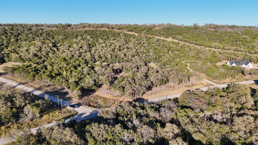 Welcome to your own wide-open piece of Texas in the beautiful Brazos Mountain Ranch community near Mineral Wells. This Tract is the perfect blank canvas for your country dreams. The land offers gently rolling terrain with plenty of usable space, ideal for building your dream home, a weekend getaway, or simply enjoying the peace and quiet that only the country can provide. Here, you’ll find room to breathe, wide blue skies stretching in every direction, and stunning sunsets that paint the horizon in color every evening. Brazos Mountain Ranch is a private, gated community designed for those who appreciate the outdoors and the slower pace of country living. Residents enjoy private river access to the Brazos River, a friendly rural atmosphere, and the kind of natural beauty that reminds you daily why Texas living is second to none. Whether you want to keep horses, raise a few animals, or just relax surrounded by nature, this property provides endless possibilities. Located just a short drive from Mineral Wells and Palo Pinto Lake, you’ll have access to local dining, shopping, and recreation while still feeling miles away from the noise of the city. With the right mix of open space and community, this property invites you to build, explore, and make lasting memories under the Texas sky. Come see what makes Brazos Mountain Ranch so special — and picture your next chapter beginning here.