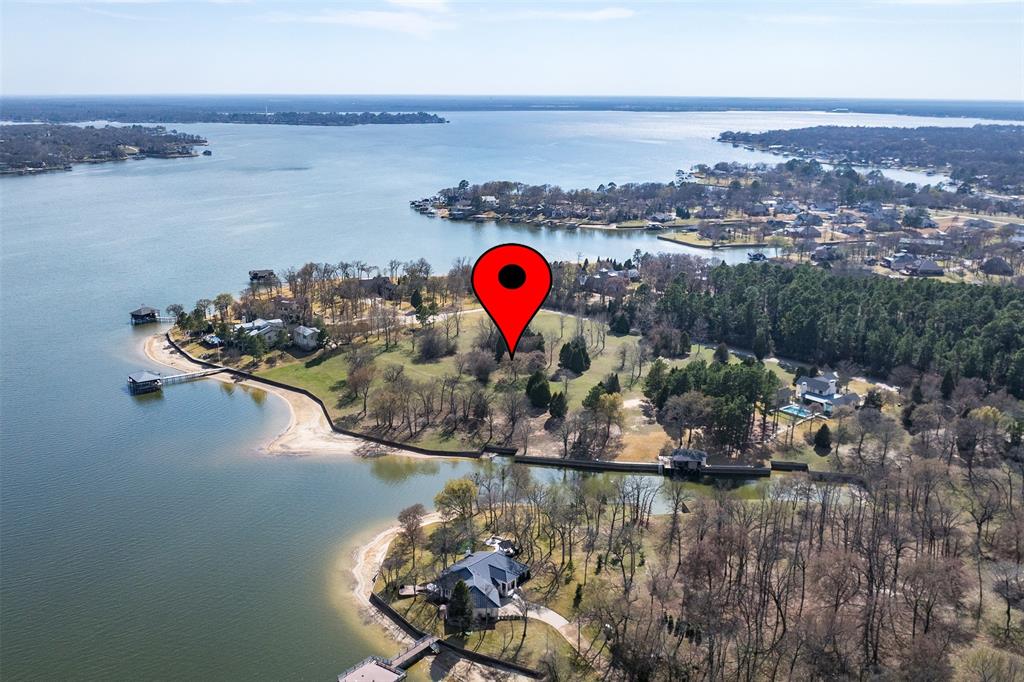 Rare opportunity on Cedar Creek Lake! This exceptional 1.62-acre waterfront lot offers over 130 feet of shoreline, providing the perfect setting to build your dream lakefront retreat. A steel retaining wall is already in place, and mature trees create a beautiful natural backdrop with spectacular open water views. Located in an upscale gated community near The Pinnacle Golf Club, the neighborhood features underground utilities, concrete streets, and impressive multi-million-dollar homes already in place. Enjoy the privacy and space of this estate-sized property with plenty of elbow room while taking in the truly breathtaking lakefront setting.