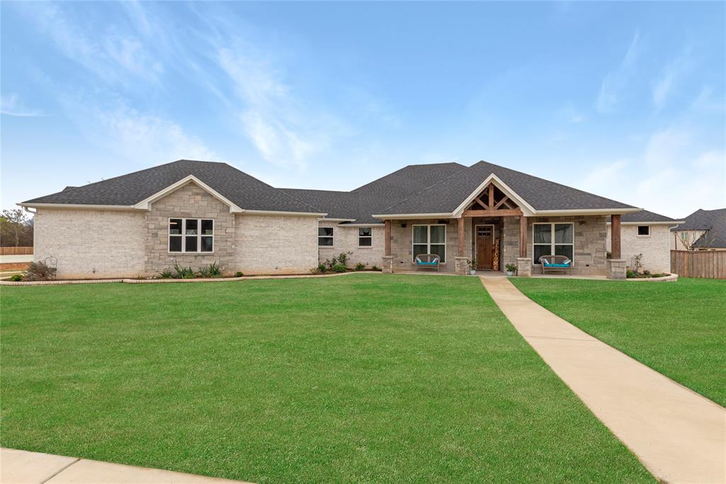 Welcome to this stunning 4-bedroom, 4-bathroom home with an extra-large 3-car garage offering 3,175 square feet of beautifully designed living space near Lake Palestine. With impressive architecture, spacious living areas, and distinctive features throughout, this home truly stands out. Immediately, you’re greeted by a large front yard and eye-catching design that makes a statement. Inside, the living room is full of charm with a beautiful fireplace, custom wood inlaid ceiling, built-in shelving, and large windows that fill the space with natural light. The open layout provides plenty of room to create a space that fits your personal style. The kitchen is both stylish and functional, featuring a French-door oven, 36” dual fuel range, oversized island, gorgeous countertops and backsplash, large farm sink, pot filler, unique light fixtures, and abundant cabinet and counter space. The dining area continues the elegant feel with its own distinctive lighting and open layout. Just off the dining room is a second living area, perfect as a media room, lounge space, or flexible living area. The office with large window and walk in closet can easily be utilized as a fifth bedroom or craft room.  All bedrooms are generously sized with plenty of natural light, while the bathrooms feature modern finishes and beautiful details. The primary suite is impressive with a large window, access to the back patio, and plenty of room to unwind. The spacious primary bathroom and closet offer stylish fixtures, ample storage, a beautiful walk-in shower and soaking tub. Outside, the backyard features a large, covered patio with vaulted ceilings and an outdoor fireplace—perfect for entertaining or relaxing. The backyard also includes a pool and plenty of open space for outdoor activities. An oversized 30×28 garage is boat and recreational equipment ready with a floor drain and indoor spigot. The 26kW generator adds even more functionality to this exceptional property near Lake Palestine.