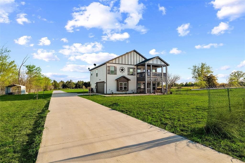 This 2020 modern farmhouse on 2.9 unrestricted acres in Quinlan offers the flexibility buyers are looking for. With 3,200 sq ft, all bedrooms are upstairs along with a spacious bonus area perfect for a game room or a second living space.

The primary suite stands out with its own private kitchenette and direct access to a balcony, ideal for morning coffee or unwinding in the evening. The ensuite bath features an oversized double-head shower and a large walk-in closet. Each secondary bedroom also includes walk-in closets.

The main kitchen is built for both daily living and entertaining, featuring quartz countertops, stainless steel appliances, and a built-in microwave. Durable luxury vinyl plank flooring runs throughout the home.

Outside, you’ll find two covered patios, dual balconies, a fenced area suitable for animals, and a chicken coop already in place and ready for finishing touches. With minimal restrictions, this property offers a wide range of potential uses.

Conveniently located off FM 276, you have easy access to Rockwall and Greenville for shopping and dining, along with close proximity to Lake Tawakoni shown in aerial views, for outdoor recreation.