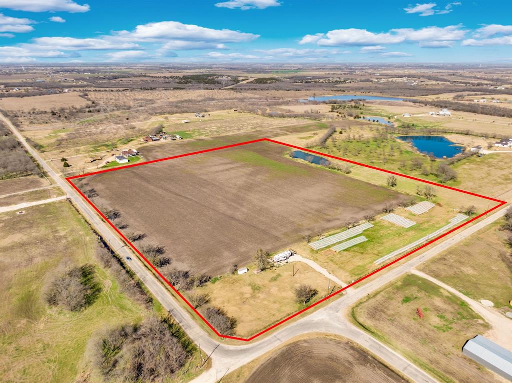 Nearly 24 acres of flat, usable land located in the county with no floodplain and no known restrictions. This tract offers extensive road frontage on both Moseley Rd and Boyce Rd, creating multiple access points and strong subdivision potential. Currently under agricultural exemption and used for hay production, the property presents immediate usability while maintaining long-term upside. Utilities are already in place with a water meter installed and serviced by Rockett Special Utility District, along with electricity installed and serviced by Navarro County Electric Cooperative. Situated just 1.4 miles from Hwy 287 and within Ennis ISD, the location provides convenient access while preserving a rural setting. With level topography, established utilities, and dual road frontage, this property offers flexibility for continued agricultural use, a private estate, small tract division, or future residential development (subject to county approval). A rare combination of access, infrastructure, and development potential in a growing corridor.