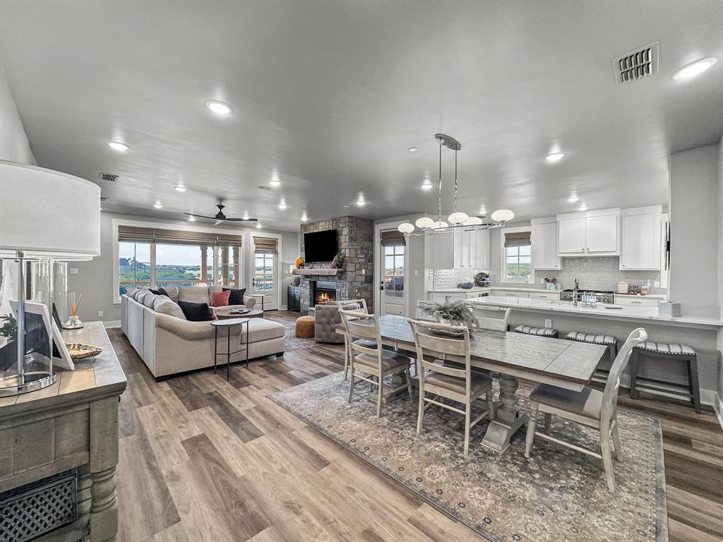 Built in 2021, this stunning fully furnished condo is located within the amenity-rich The Harbor at Possum Kingdom community and showcases a sleek modern-contemporary design throughout. Thoughtfully designed with an open-concept layout, the living, kitchen, and dining spaces seamlessly flow together creating the perfect setting for entertaining or relaxing at the lake.

Enjoy breathtaking lake views from the expansive wraparound patio, offering scenic water views in every direction. This turnkey residence features 3 spacious bedrooms, 3 full baths, plus a half bath, providing ample space for family and guests alike.

Additional highlights include an assigned garage space and covered carport parking for added convenience. Located just a short walk from the resort-style pool, fitness center, marina, dining, and upscale community amenities, this lock-and-leave lake retreat offers the ideal blend of luxury, comfort, and convenience at Possum Kingdom Lake.