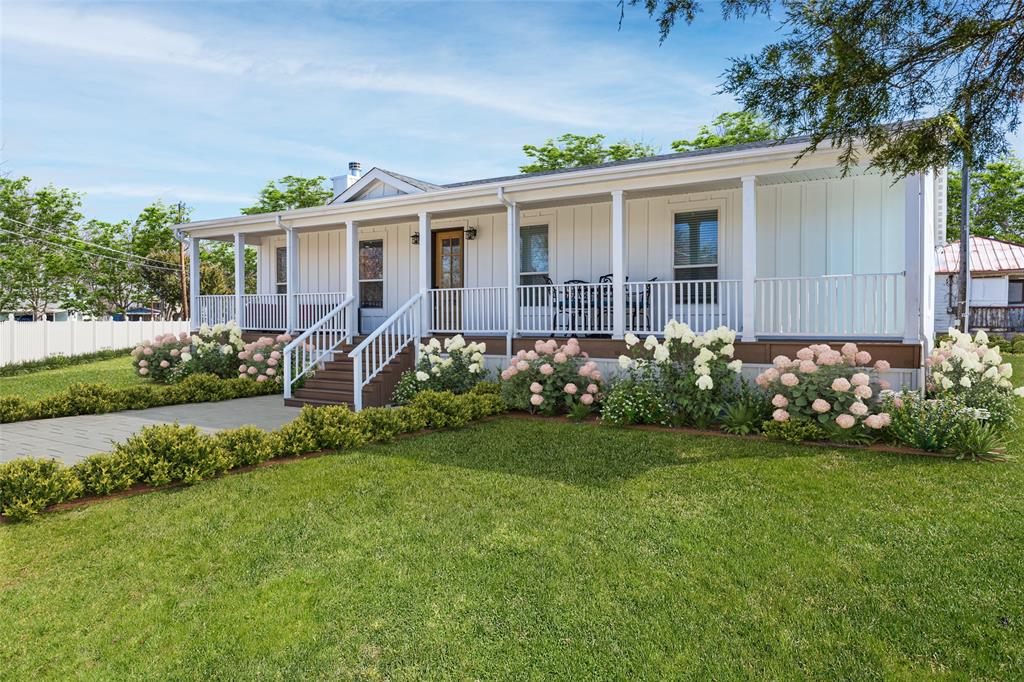 Enjoy peaceful lake living in this 2023 site-built modular home in Deep Water Point at Lake Lavon. Assembled onsite on a permanent foundation, this home offers the quality of traditional construction with the precision of modern manufacturing. Spanning approximately 2,565 square feet across two oversized lots, this four-bedroom, two-bath home features a smart split-bedroom layout and open-concept design with spacious living, dining, and kitchen areas at the heart of the home. The kitchen showcases stone countertops, a large island, solid wood cabinetry, and stainless steel appliances, offering abundant workspace and storage. Luxury vinyl plank flooring flows throughout, and large picture windows fill the home with natural light. A stacked stone fireplace anchors the great room, while glass-paned doors enhance the connection between indoors and out. The primary suite offers a generous bedroom, a walk-in closet, and a spa-like ensuite bath with dual sinks, a freestanding soaking tub, a frameless glass shower with dual showerheads, and a private water closet. Each secondary bedroom includes a walk-in closet, and a shared full bath is conveniently located off the hallway. A dedicated utility room with built-ins adds everyday convenience. Built for comfort and efficiency, the home includes 2x6 exterior walls with R-19 insulation, R-30 attic insulation, energy-efficient Low-E windows, and a programmable thermostat. A 24.095 kW solar panel system, installed in 2023, was designed to offset most of the home’s energy needs, producing over 32,000 kWh in its first year. Outdoor living shines with a full-length front porch overlooking open space and water. The level double lot provides room for gardens, pets, recreation, or future expansion. Furnishings negotiable. Minutes to Rockwall, Wylie, and greater Dallas, this move-in-ready home offers a rare opportunity to own a spacious, energy-conscious site-built modular home with style, comfort, and room to grow.