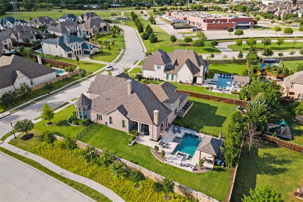Perfectly situated on a half acre corner lot just steps away from highly acclaimed Cockrell Elementary in desirable Whitley Place, this luxury home has it all! Built by Drees, this magnificent home boasts over 5,300 sq ft of open concept living with 5 bedrooms, 4 full baths, numerous living spaces, an oversized study, media room with wet bar & fridge, huge game room, & a walk in bar area with a wine fridge & a beverage fridge! The kitchen of your dreams with white quartzite countertops, high end appliances, walk in pantry and ample storage. Designer lighting and colors throughout, surround sound audio inside and out, tons of oversized walk in closets, large laundry room, and floor to ceiling windows bring in natural light and views of your backyard oasis from across the back of the entire home. Travertine stone surrounds the sports pool, hot tub, fire pit and outdoor kitchen that dreams are made of! Plenty of green space for the kids & a 4 car garage and gated porte cochere entry.