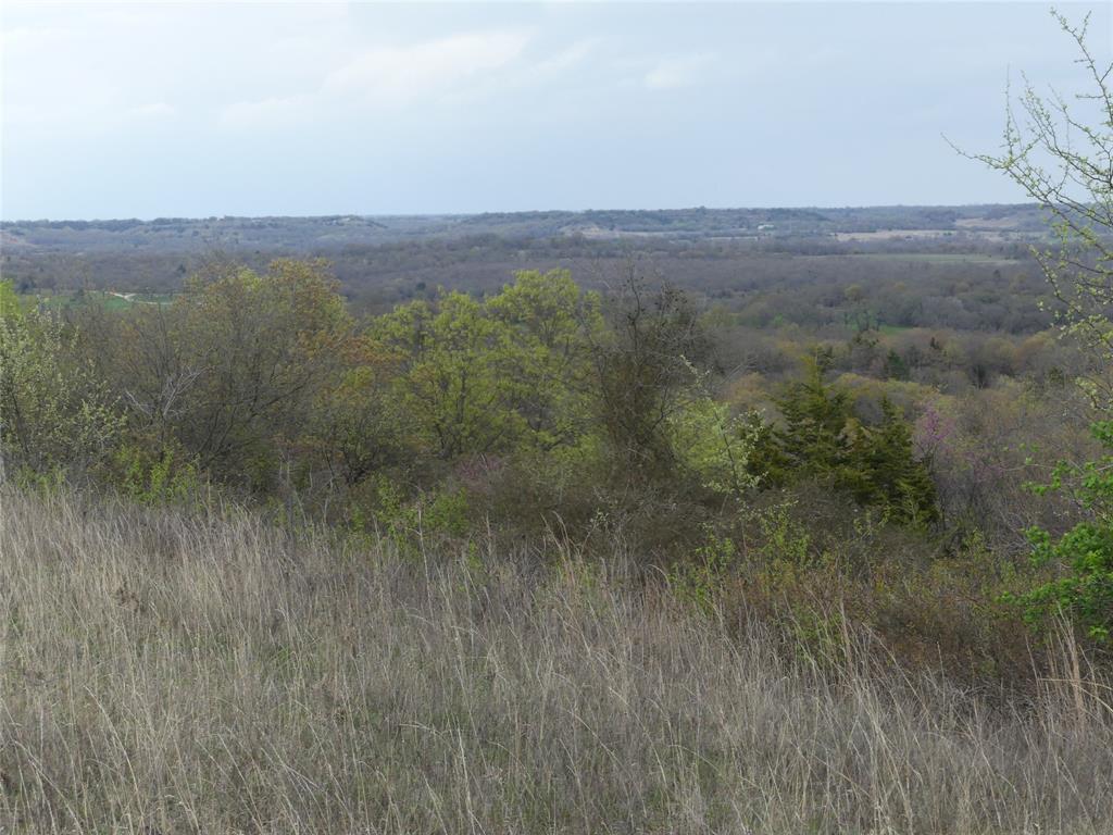 With over 200 feet of elevation change, you won't find many properties like this. From around 1050 feet down along the live creek, up to 1250 feet at the top of the hill. This is one of the highest points in Montague County. The property is about 60-70% wooded, with openings scattered throughout. There is a good well on the property that is ran from a solar panel. There is also a camper and tractor with mower that will stay with the property. Lots of wildlife. Deer, hogs, turkey, and a variety of small animals. The good-sized pond has been stocked but hasn't been fished in a while.  This is a great place for a weekend, hunting season, or a lifetime. Don't let this one get away.