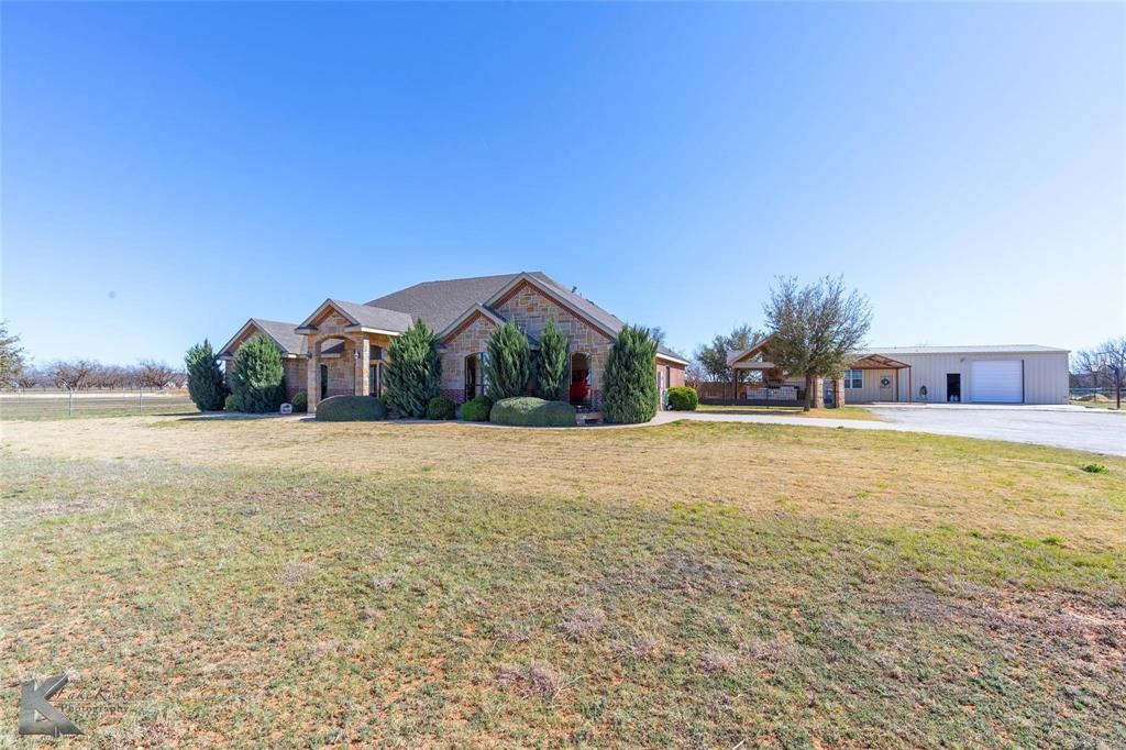 House, Guest House, Shop, Pool with Outdoor Kitchen, Fireplace & Cabana on one end and Outdoor Fireplace & Cabana on the other. All of this is situated on 10.7 serene Ag Exempt acres. Bring your growing family and your livestock and enjoy the peace and quiet of country living. Combined luxury & functional layout is ideal for hosting. The home features an open concept kitchen, living, dining. With an abundance of counter top space, a central prep island, and premium stainless-steel appliances surrounded by expansive cabinetry, this kitchen is a Chef’s Dream! Boastful living room has custom moldings & stone fireplace which anchors the room. Split floorplan design creates privacy for the primary bedroom and ensuite. The spacious primary suite offers a lavish ensuite with dual sinks, a jetted tub, a walk-in tiled shower with dual shower heads and a storm rated walk-in closet. Secondary bedrooms share well equipped bath offering a large vanity, walk-in shower, and soaking tub. Upon entrance in the home, French doors usher you into the stately office perfect for working from home. Backyard oasis creates tranquility with a waterfall cascading into the refreshing pool. 30 X 30 Shop has electric and a roll up door. Primary Home is 4 bed, 2 bath, 2692 sq ft and Guest house is 2 bed, 1 full bath, kitchenette and open living room with corner fireplace, 690 sq ft.