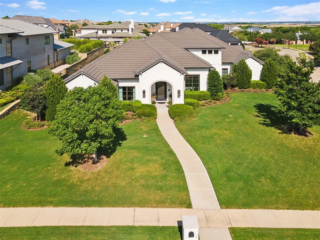 Nestled in the exclusive Montserrat neighborhood, this custom-built HGC home defines luxury living. The primarily single-level floor plan includes a game room, full bath, and storage room upstairs. Key features include a temperature-controlled wine wall, spacious office, and a kitchen that opens to a cozy family room with a fireplace. The primary suite, located on the main floor, boasts a large bath and walk-in closets. Three more bedrooms and a family room are also on the main level. Extras include a Control4 system, exterior cameras, three car garage, included TVs, and a concrete tile roof.