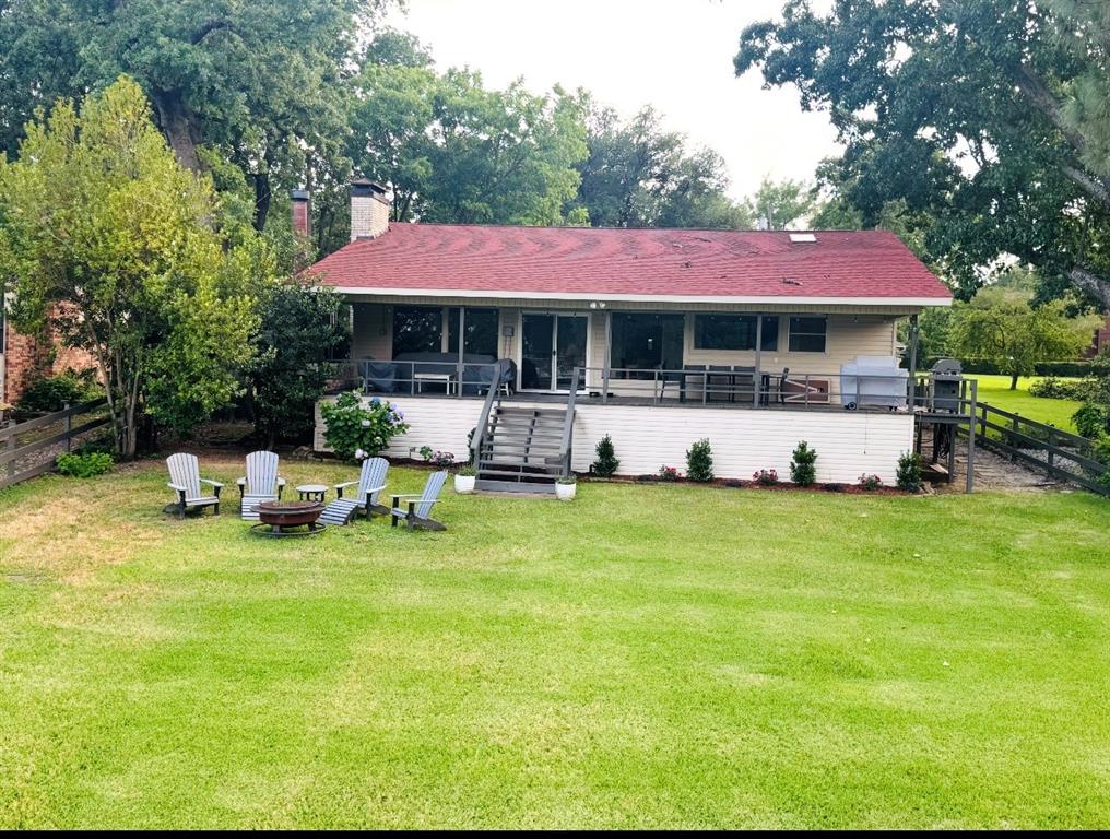 Charming, tastefully updated, and ready to enjoy!  The main house offers two bedrooms and two baths with an open-concept design, vaulted ceilings, a cozy fireplace, and large picture windows showcasing wonderful lake views.  The spacious kitchen features gas cooking, a center island and an oversized eating bar - perfect for gathering and entertaining.  A versatile bunkhouse adds extra space for sleeping or gaming and includes a full bath.  Outdoor living truly shines with a large covered porch complete with a fireplace, plus a generous boathouse with a party deck, all nestled on deep water in a picturesque cove.
