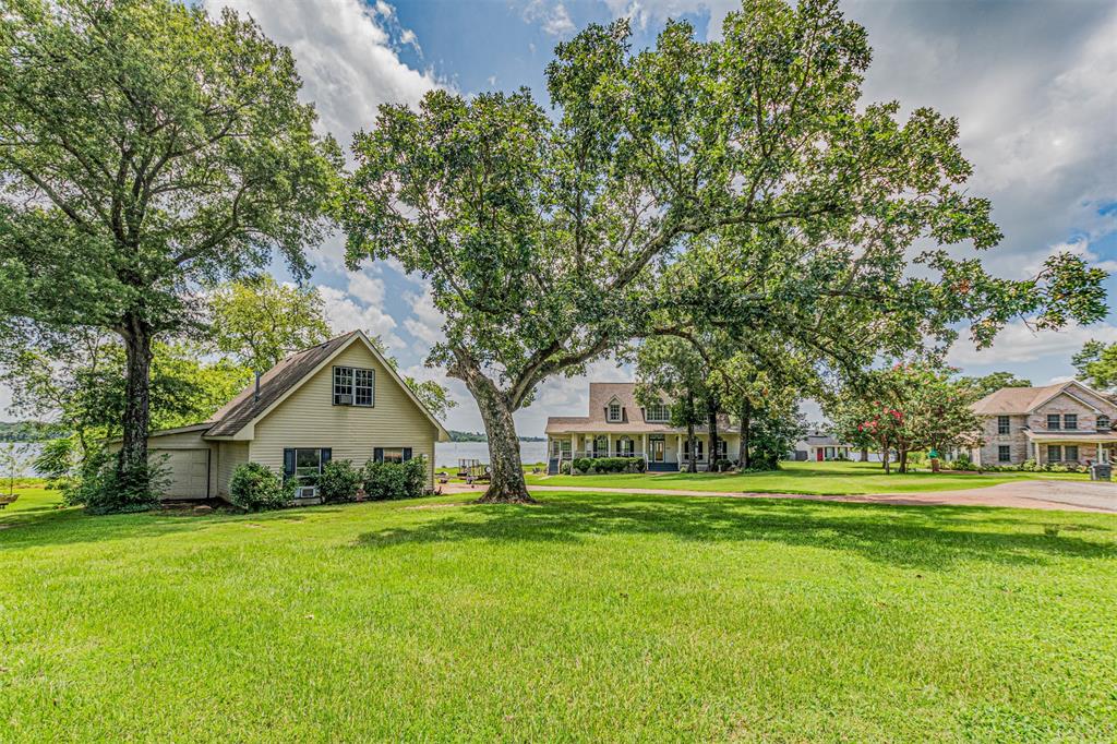 Welcome to your dream lake retreat! This fantastic property sits on 3.5+ acres of peaceful, scenic land located on a beautiful peninsula on world-famous Lake Fork. Over 700 FEET of shoreline. Whether you're looking for a full-time residence, weekend escape, or income-producing getaway, this unique property has it all.

The updated main house offers 3 spacious bedrooms and 2.5 bathrooms. The large open living area creates the perfect place to relax or entertain, with plenty of natural light and room to spread out. The eat-in kitchen is both stylish and functional, featuring granite countertops, updated appliances, and ample storage. Just off the kitchen, you’ll find a generous laundry and storage area that adds extra convenience.

Step outside and enjoy the oversized porches on both the front and back of the home—perfect for morning coffee, evening sunsets, or gatherings with friends and family. The backyard includes a refreshing pool, creating the perfect place to cool off or unwind during the warm Texas summers.

A separate guest house sits on the property and includes 2 bedrooms, 1 full bathroom, a full kitchen, and a spacious living area. This extra space is ideal for visiting family and friends or can serve as a fantastic source of rental income, whether short-term or long-term.

The property also includes a large garage with unfinished living space above, offering the potential for even more room or a future apartment or game room.

For those who love to fish or enjoy time on the water, the large boat dock is fully equipped for world-class fishing and lake adventures. Whether you’re heading out for trophy bass or just enjoying a sunset cruise, this setup makes lake life easy and enjoyable.

With thoughtful updates throughout, this property is move-in ready and well-maintained. Plus, the leaseback on the waterfront is only $65 per year, offering incredible value.

Don’t miss this rare opportunity to own a piece of paradise on Lake Fork!