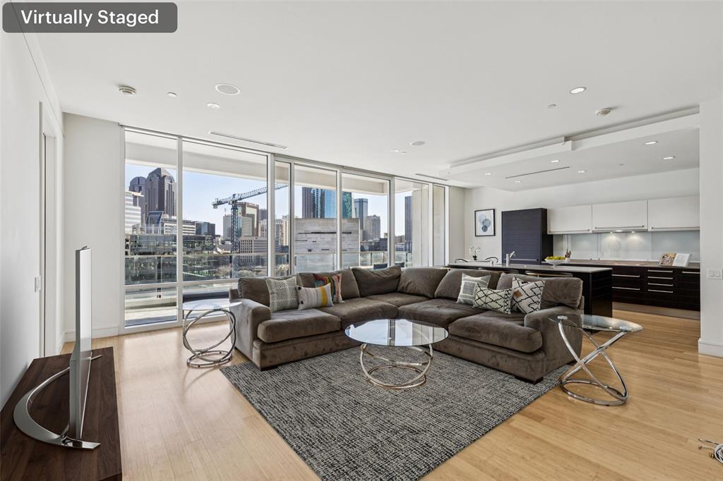Stunning luxury condo at W Dallas – Victory Hotel & Residences featuring one of the most sought-after northwest-facing views. Enjoy sweeping city and skyline vistas from the expansive patio-style balcony, perfectly positioned for unforgettable sunsets and downtown scenery. At the heart of the home is a spacious living room flooded with natural light, seamlessly connecting indoor living with the outdoor balcony and its incredible views.  The sleek, modern kitchen offers a large island, abundant cabinetry, and clean contemporary lines—ideal for both everyday living and entertaining. Rich bamboo flooring adds warmth and sophistication throughout the open-concept floorplan. The residence is impressively spacious and features two large bedrooms, each with its own ensuite bathroom and walk-in closet, providing privacy and comfort for owners and guests alike.  The primary suite is a true retreat with a custom-designed closet and a spa-like ensuite bath complete with dual vanities, a soaking tub, and a separate walk-in shower. A full-size front-load washer and dryer are conveniently located in a utility closet with additional storage cabinetry.  Residents enjoy world-class, amenity-rich living including 24-hour concierge service, a fully equipped fitness center, a stunning resort-style pool, and beautifully designed outdoor entertaining areas with built-in grills. Approx. 6x11' storage closet in hall near front door. The nearby Goldman Sachs tower currently under construction (estimated completion 2028) still allows for wide, open downtown views.  Ideally located just one block from American Airlines Center and moments from the Katy Trail, with exceptional dining, shopping, and entertainment within a few blocks. Ask about owner discounts to the W Hotel & spa next door.
