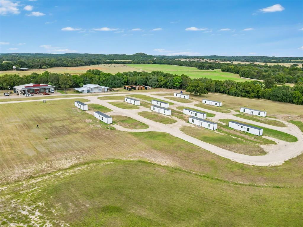 Exceptional 18.885 Acre Investment Property with Income Producing Units & Expansion Potential.

Discover an unparalleled opportunity with this versatile 18.885 acre commercial property, perfectly positioned for investors, developers, or business owners seeking scale, flexibility, and multiple revenue streams. With ample room for future expansion, this turnkey property already features a diverse mix of income-producing units and valuable infrastructure.

The property includes 11 modern container homes, each thoughtfully designed for efficiency and long-term durability; two charming tiny homes ideal for short-term rentals or workforce housing; and a spacious 5 Bed - 4 Bath main house suitable for a large family, corporate lodging, or additional rental income. A large, 3200 sqft multi-use shop provides excellent storage, workspace, or operational headquarters for a variety of commercial ventures. Main house is complete with a rain catch system, commercial water softener, 2 Tesla Powerwalls, and a 44 panel solar system.

5 additional containers are included at the listed price and can be put in place with some minor infrastructure additions.

With expansive acreage still available for development, the possibilities are endless. Expand the existing rental community, add RV sites, build additional structures, or repurpose the land to suit your business vision. Utilities and site improvements are already in place to streamline future growth.

Whether you’re looking to grow a hospitality operation, create a workforce housing hub, or establish a unique destination property, this 18-acre offering delivers a rare combination of income, infrastructure, and limitless potential.