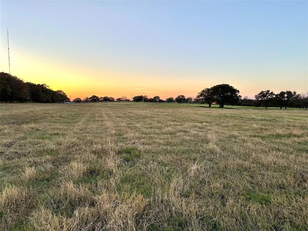 Turn your dreams of country living into reality on this stunning 22-acre parcel situated along the desirable W Line Road in Collinsville.  This 22-acre parcel sits at the high point of the surrounding property, runs over 2699 feet back from the road, and has over 353 feet of width (which is wider than the length of a football field).  With its picturesque rolling hills, abundant trees, and convenient access to town, it's the ideal location to construct the custom home or barndominium you've always envisioned, with water and electricity readily available at the road.  The sandy loam soil and coastal Bermuda grass make this land perfect for raising cattle or horses.  Currently, the property benefits from a hay agricultural exemption and produced over 40 round bales in a single cutting this past season.  Additionally, wildlife enthusiasts will appreciate the sightings of deer and other wildlife in the property's back area.  Conveniently located just 2.5 miles (approximately 4 minutes) from HWY 377 and 9.1 miles (around 11 minutes) from HWY 82 in Whitesboro, this land offers both tranquility and accessibility.