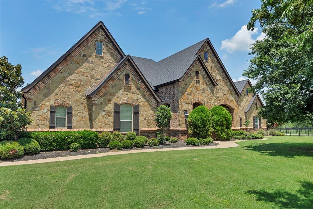 Lakefront luxury meets refined Texas living at this exceptional Eagle Mountain Lake estate in the exclusive gated community of The Orchards. Situated on approximately 3.74 acres with an impressive stretch of waterfront, this custom-built home offers privacy, space, and resort-style amenities just minutes from Fort Worth.
Inside, you’ll find 6 spacious bedrooms, 4 full baths, a dedicated office, and an open-concept layout ideal for everyday living and entertaining. The gourmet kitchen features granite countertops, a built-in commercial-grade refrigerator, double ovens, gas cooktop with pot filler, oversized island, breakfast bar, walk-in pantry, and butler’s pantry. Rich wood flooring, custom cabinetry, designer lighting, plantation shutters, and electric shades highlight the craftsmanship throughout.
The private primary suite offers a spa-inspired bath with dual vanities, garden tub, separate shower, and custom closet system. Upstairs includes additional bedrooms, a large game room, and flexible guest retreat space.
Step outside to a true lakeside retreat with a covered patio, outdoor fireplace, misting system, built-in grill, and fire pit. A concrete walking and golf cart path leads to the water, passing a putting green along the way. The two-level dock includes a boat slip, jet ski lifts, tanning deck, and a fully equipped boathouse.
With western-facing views, enjoy breathtaking sunsets that paint the lake in vibrant color each evening.
It’s all about the details in this home, from hand-selected finishes and intricate millwork to built-ins, custom storage, and seamless indoor-outdoor flow. Every space is thoughtfully designed to blend elegance, comfort, and function.