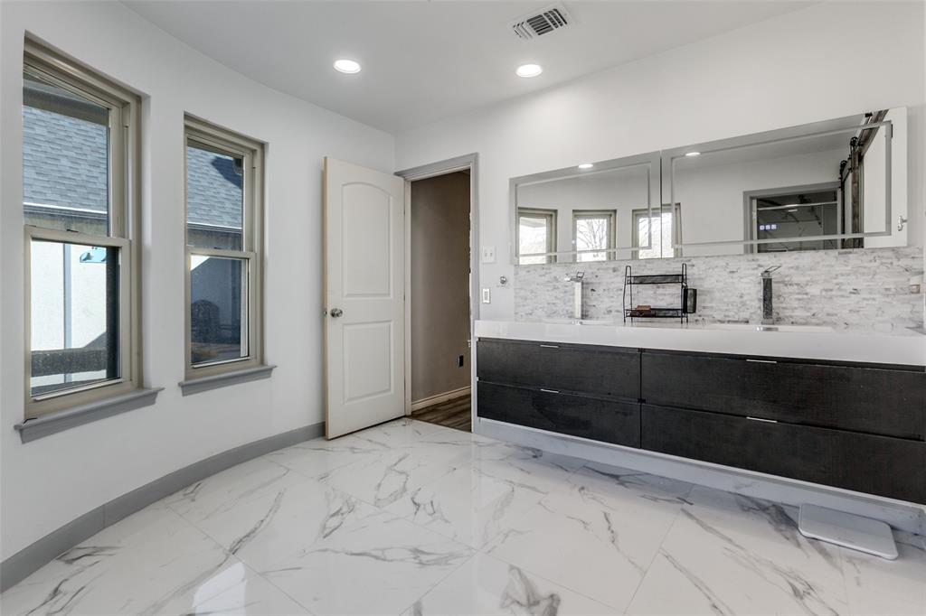 Located minutes from Sherrill Park Golf Course, this remodeled single-story showplace centers on a private backyard oasis featuring a sparkling pool, spa, stone waterfalls, and artificial turf. The vaulted living area is anchored by a brick fireplace and new double sliding doors that seamlessly blend indoor and outdoor living. The chef’s kitchen offers granite countertops, an island, and stainless steel appliances, including a double oven and refrigerator. For ultimate relaxation, the master retreat provides direct backyard access and a spa-like ensuite with a floating double vanity and an oversized luxury shower equipped with dual rain heads, body jets, and Bluetooth LED lighting. A versatile front game room with a full bath and wet bar easily serves as a fifth bedroom. Recent upgrades include Champion windows (2020), new exterior siding, and durable LVP flooring throughout the entire home.