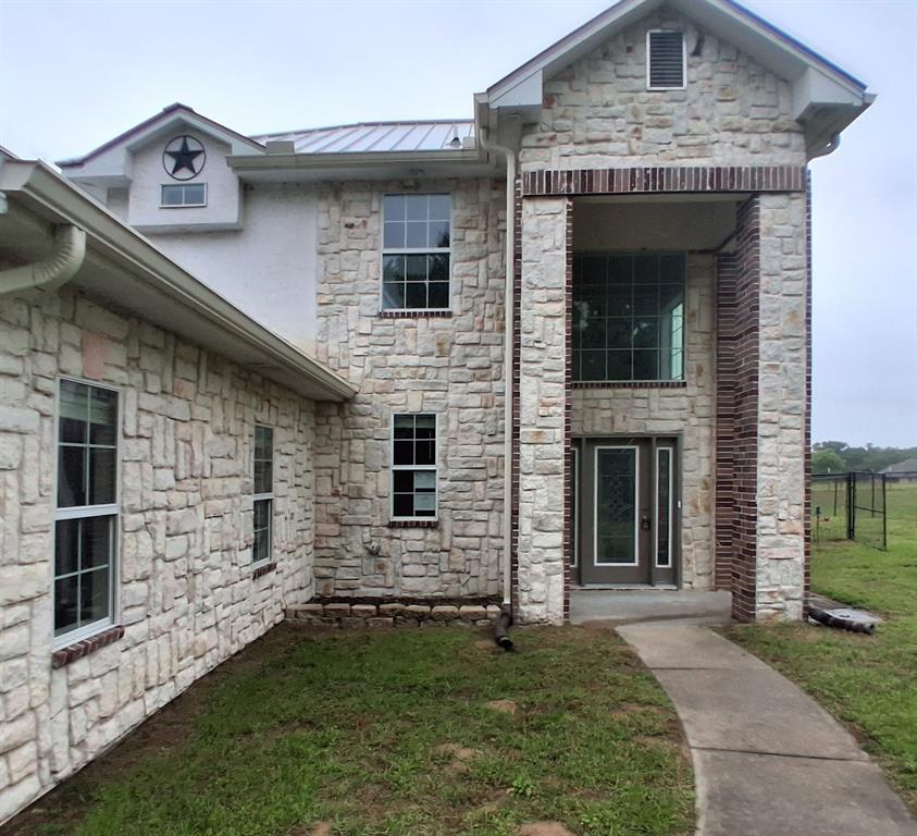 Spring Creek Subdivision of Emory  Tx ! This home offers both elegance and privacy. Set on 1.565 acres in a quiet cul-de-sac and surrounded by mature trees, the property feels like a serene retreat. The open concept floor plan offers a kitchen with breakfast bar, spacious primary suite with a  gas fireplace, dual vanities, a deep jetted tub, separate shower, and a unique split closet layout for added convenience. Upstairs, you'll find two additional bedrooms connected by a Jack & Jill bath. Outdoors, enjoy your own river rock patio area with a built-in firepit, fenced backyard, stone patio and all set on over 1.50 acres. Attached 2 car garage, beautiful lot and more. Sold AS-IS.
