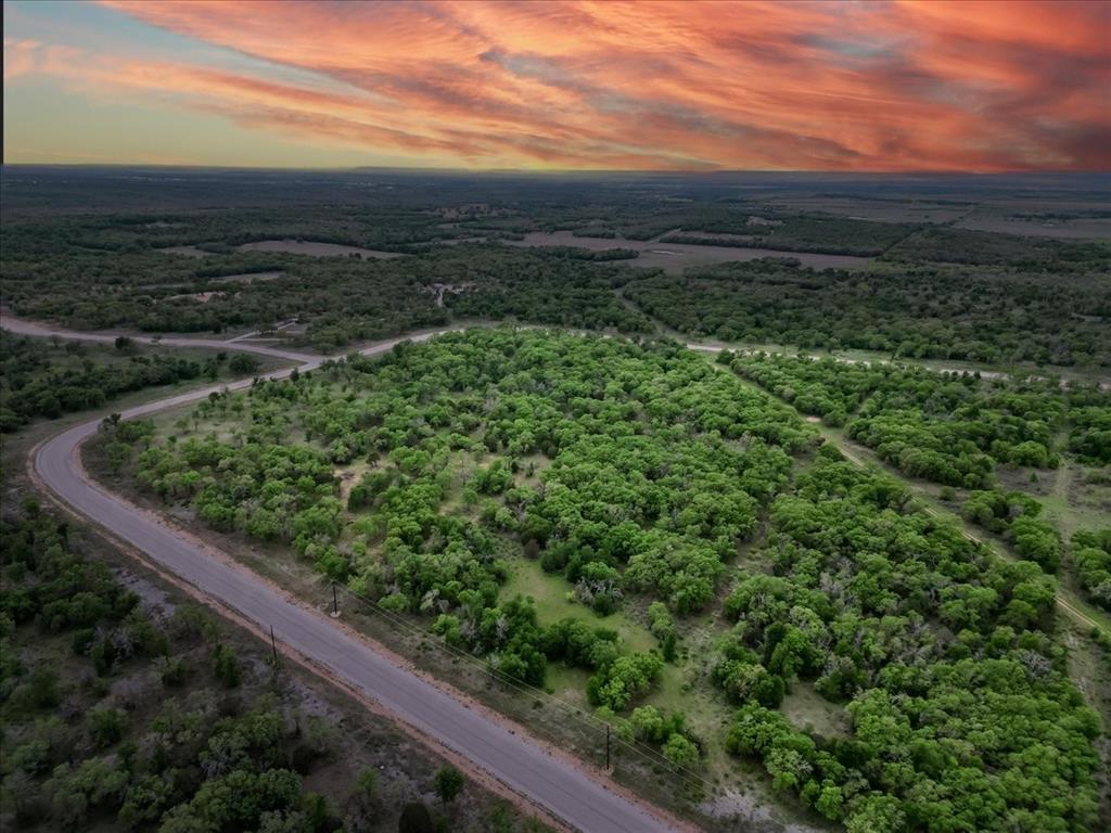 Looking for 5 acres of peaceful paradise in the country? This could be IT! Tucked into the Paradise Oaks Ranch development 19 minutes from Mineral Wells and only minutes to the towns of Graford or Perrin. The land is mostly level with an abundance of trees including oaks and cedars. It's the perfect place to build your new home or vacation getaway. BARNDOMINIUMS ARE ALLOWED! Property is Ag exempt as it is part of a grazing association. Development includes gated access & a community park that features a playground, covered picnic tables, BBQ's & a pickle ball court! No manufactured homes are allowed.